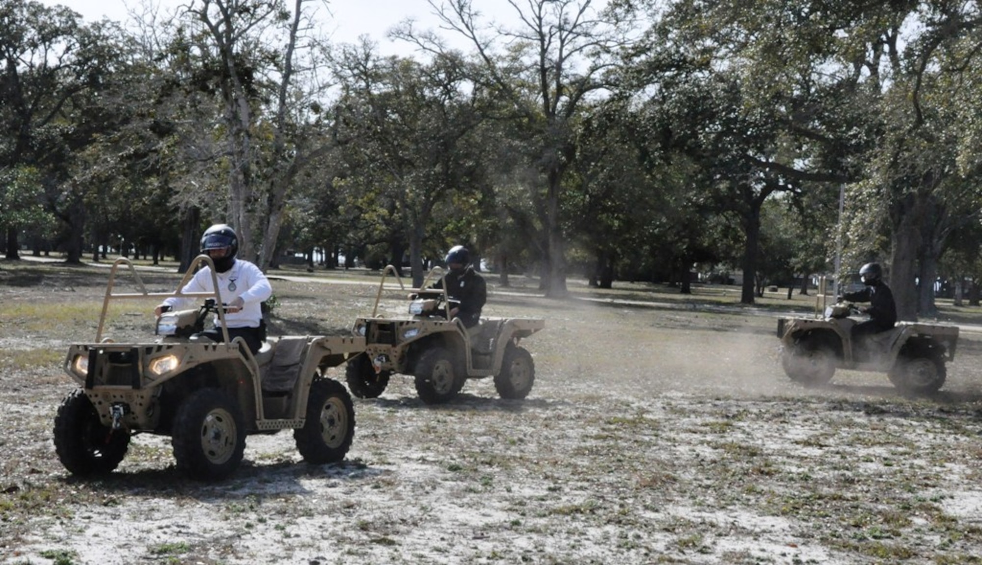 Senior Airman Justin Paczensy, Staff Sgt. Andrew Mezzetti and Senior Airman Tyler Brumfield, 325th Security Forces Squadron community police, familiarize themselves with the newest addition to the community police’s patrol inventory, the all-terrain vehicle. (U.S. Air Force photo by Staff Sgt. Rachelle Elsea)