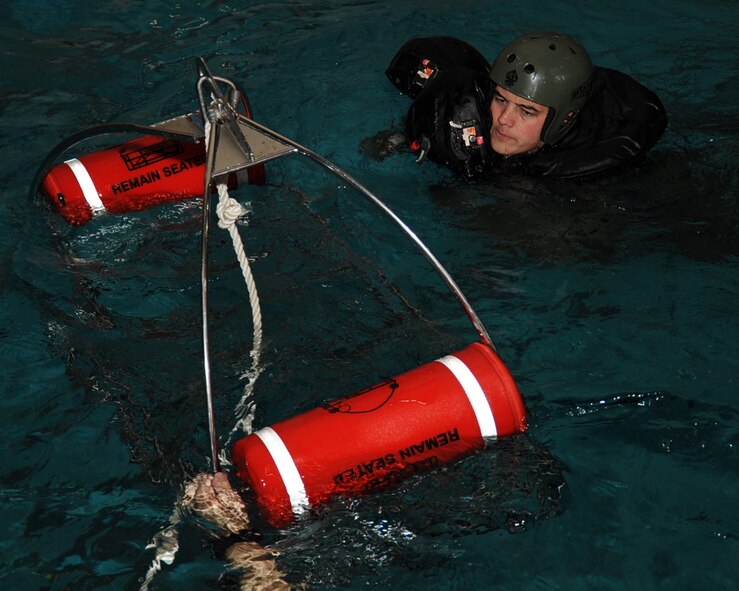 1st Lt. Andrew Greenhill, 20th Bomb Squadron electronic warfare officer, swims to a rescue basket during Survival, Evasion, Resistance and Escape water survival training at Louisiana State University Shreveport Natatorium, Shreveport, La., Jan. 22. The training gave aircrew a hands-on experience using their survival equipment. (U.S. Air Force photo/Senior Airman Sean Martin)