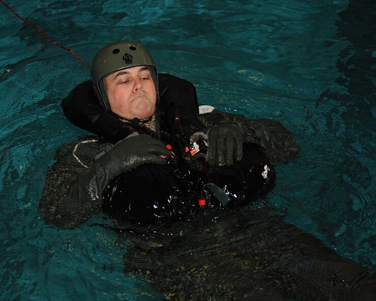 1st Lt. Andrew Greenhill, 20th Bomb Squadron electronic warfare officer, is dragged through the water by other participants during Survival, Evasion, Resistance and Escape water survival training at Louisiana State University Shreveport Natatorium, Shreveport, La., Jan. 22. The training allows aircrew to become proficient in using their equipment to survive in the event of a crash. (U.S. Air Force photo/Senior Airman Sean Martin)