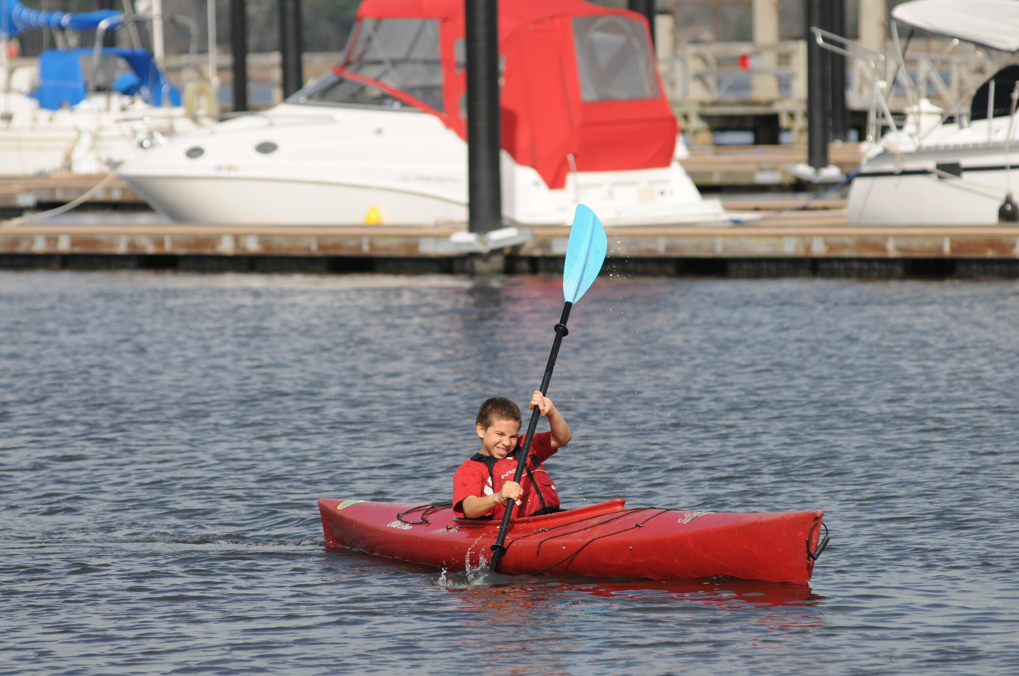 Twelve-year-old Andrew Reed, son of Tracy and Maj. Wallace Reed, 333rd Training Squadron, paddles himself toward the finish line in a kayak during the polar bear regatta Jan. 19, 2013, at Marina Park, Keesler Air Force Base, Miss.  The event was sponsored by outdoor recreation.  (U.S. Air Force photo by Kemberly Groue)