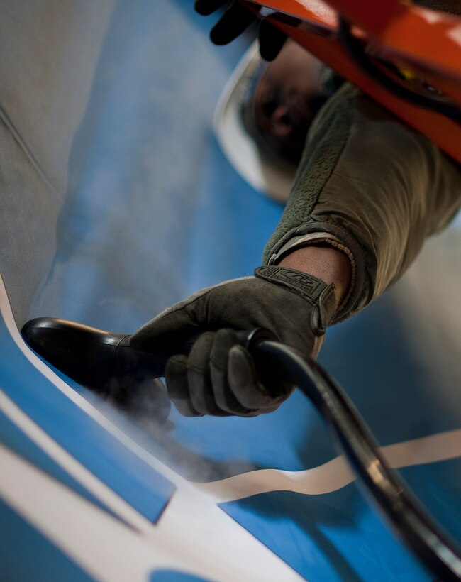 Senior Airman Derek Lawson, 11th Civil Engineer Squadron structural apprentice, steams the wrinkles out of the U.S. Air Force banner Jan. 22, 2013 at Joint Base Andrews, Md., in preparation for the Chief Master Sergeant of the Air Force Transition Ceremony here, Jan 24. On Wednesday, Chief Master Sgt. James A. Cody will become the 17th CMSAF, following the retirement and transition of Chief Master Sgt. of the Air Force James Roy. Roy's retirement will culminate more than 30 years of service. (U.S. Air Force photo /Staff Sgt. Perry Aston)