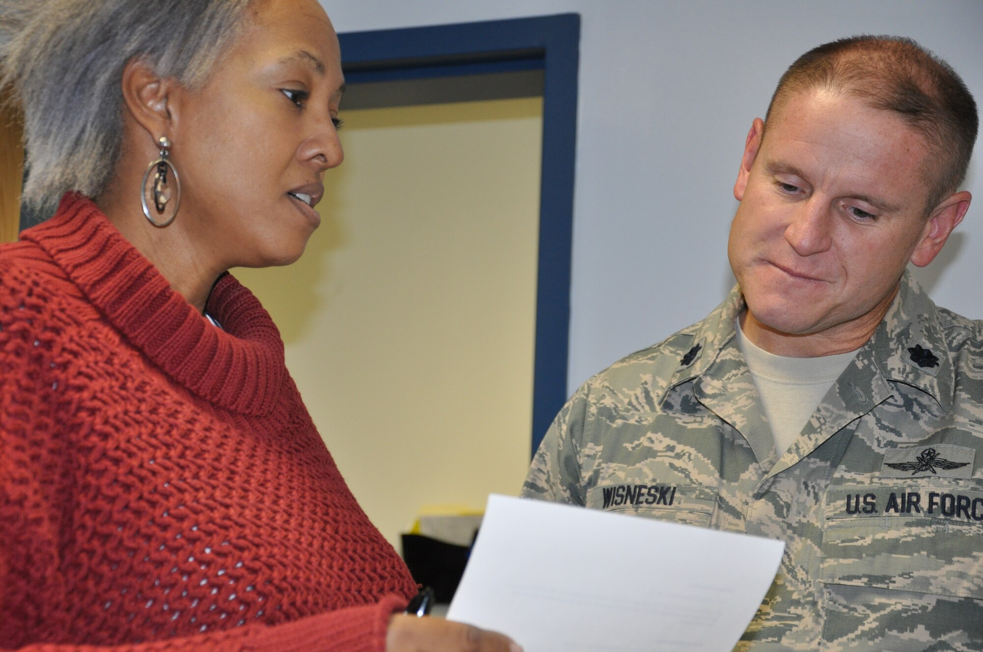Lisa Jones, Everitt Middle School administrative assistant, and Lt. Col. Wayne Wisneski, 325th Communication Squadron commander, discuss the role Airmen will have with students as part of the Adopt-a-School Program. The program allows Airmen to provide a positive role model to students in the local area. (U.S. Air Force photo by Ashley M. Wright)
