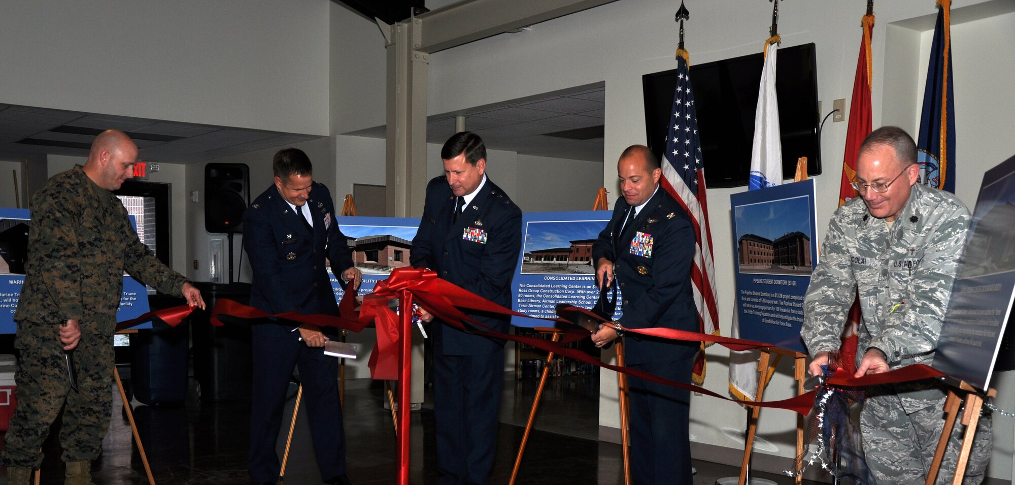 GOODFELLOW AIR FORCE BASE, Texas – (left) Marine Corps Maj. Douglas March, Marine Corps Detachment Commanding Officer, Col. Paul Bugenske, 17th Mission Support Group Commander, Maj. Gen. Leonard Patrick, 2nd Air Force Commander, Col. Mark Damiano, 17th Training Wing Commander, and Lt. Col. Steven Nicolai, 17th Training Wing chaplain, cut ribbons for the Multi-Facility Ribbon Cutting Ceremony at the Chapel Student Center-Crossroads here, Jan. 17. The ribbons were cut for Marine Training Leaders Building, Cressman Dining Facility, Consolidated Learning Center, a Pipeline Student Dormitory and the Chapel Student Center-Crossroads. (U.S. Air Force photo/ Airman 1st Class Joshua Edwards)