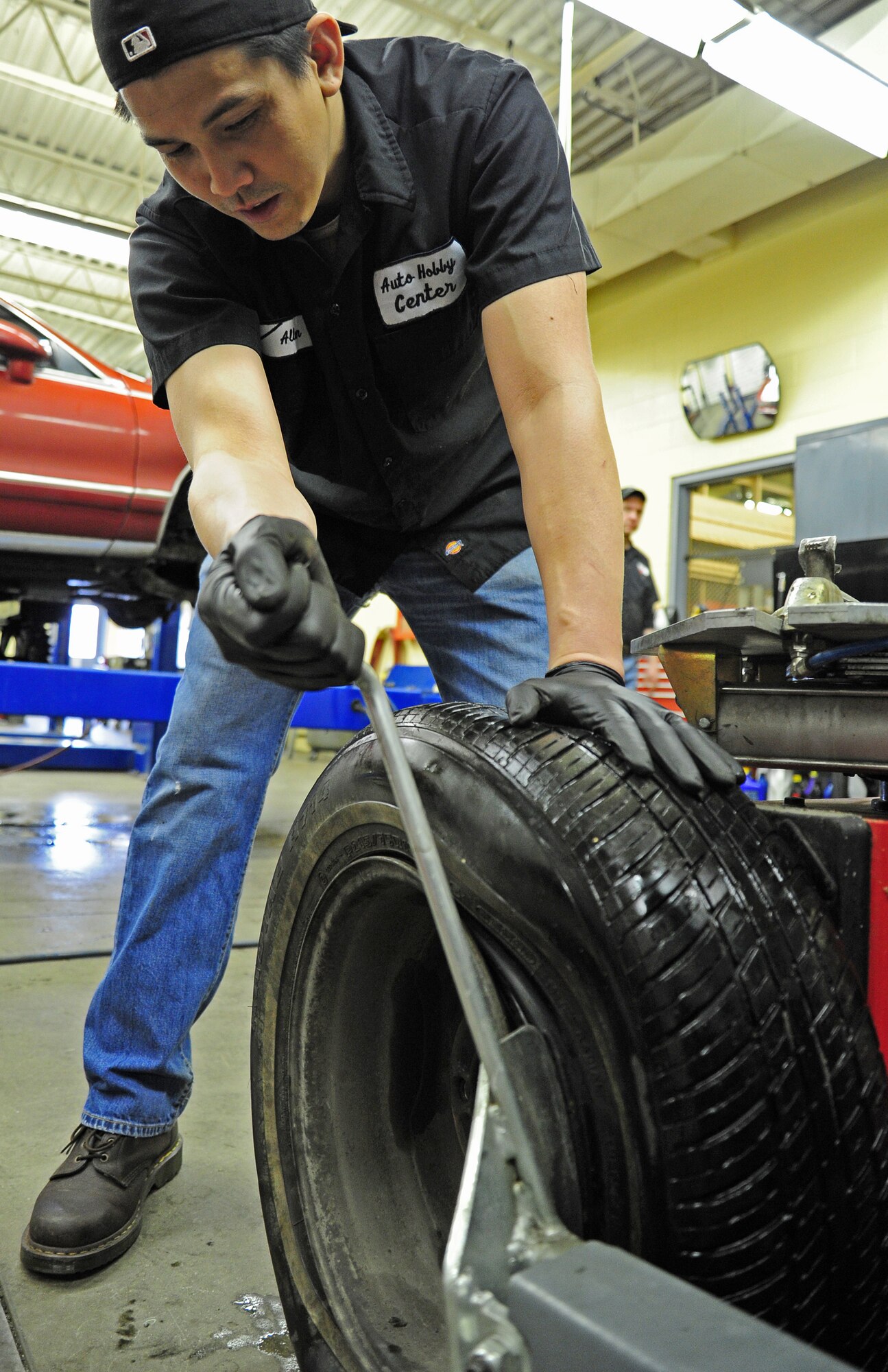 Allen Aniciete, 92nd Force Support Squadron mechanic, removes a rim using a bead breaker machine at the auto hobby shop on Fairchild Air Force Base, Wash., Jan. 18, 2013. Allen has worked at the auto shop for two years. (U.S. Air Force photo by Airman 1st Class Janelle Patiño)