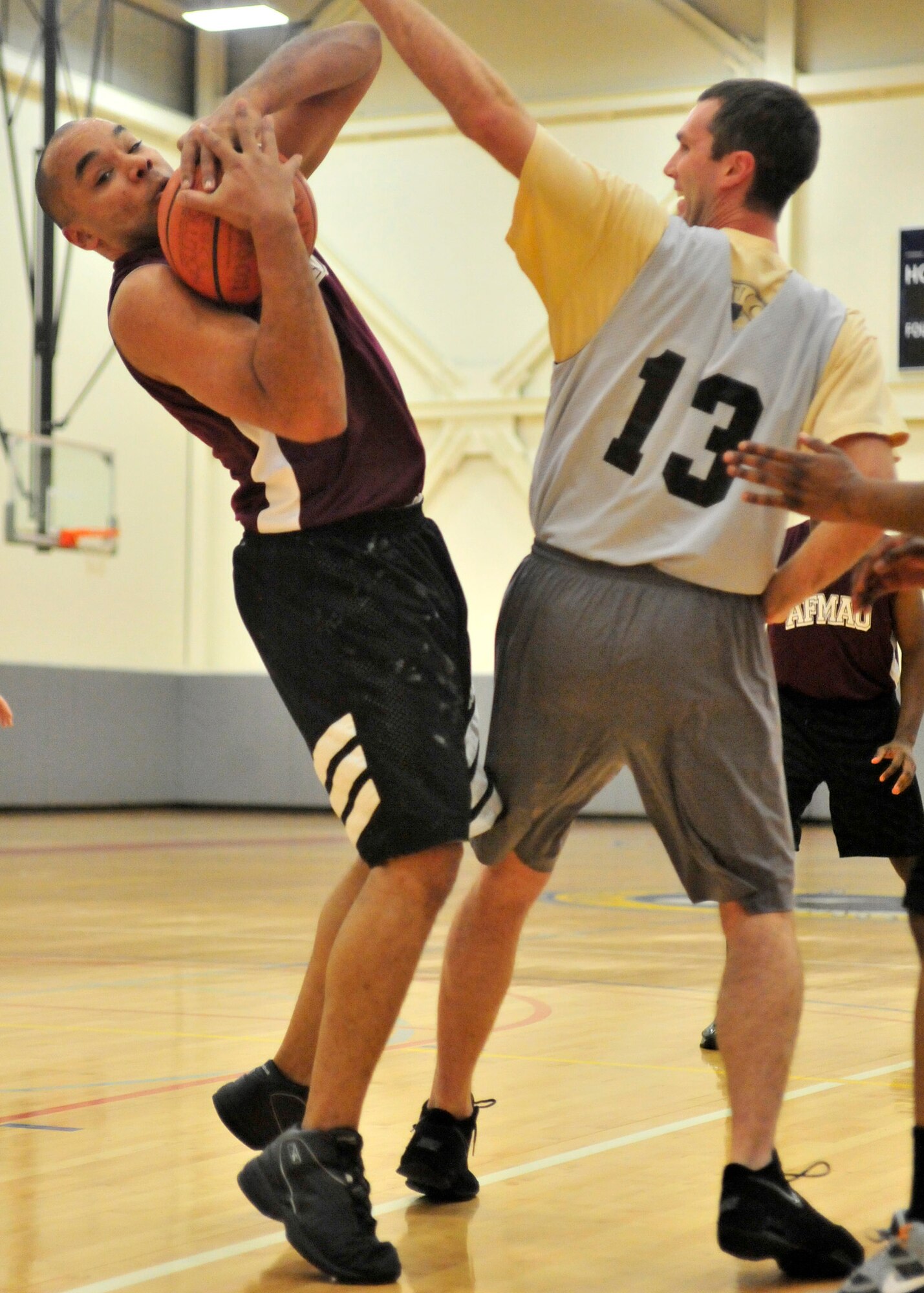 Nathan Carr, Air Force Mortuary Affairs Operations forward, steals a pass from Brett Royer, 9th Airlift Squadron forward, during an American League intramural basketball game Jan. 17, 2013, at the fitness center on Dover Air Force Base, Del. The 9th AS defeated AFMAO 42-37 to notch its third win in a row. (U.S. Air Force photo by Tech. Sgt. Chuck Walker)