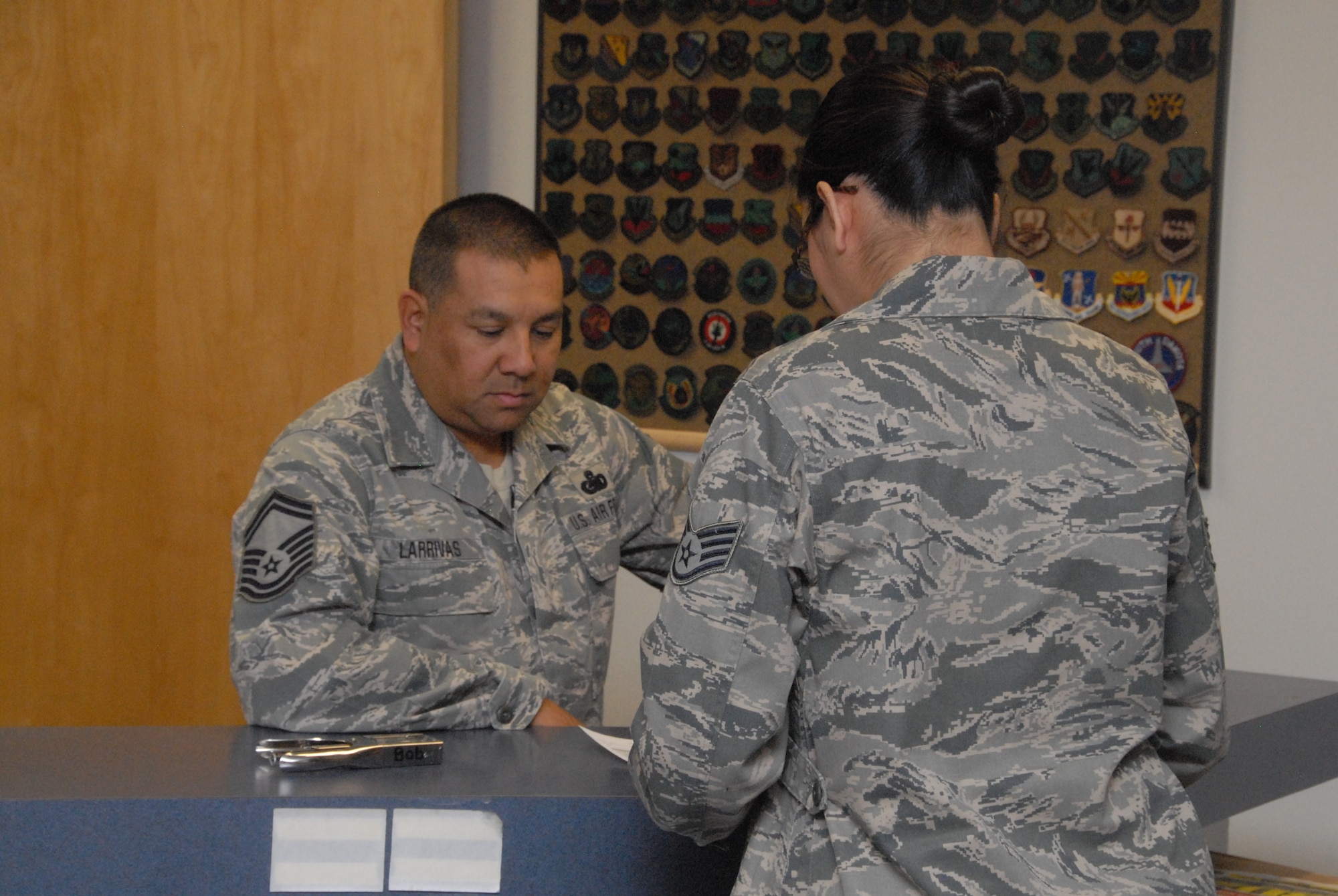 Senior Master Sgt. Daniel Larrivas is fuels supervisor in the Fuel Management Flight discusses uniform options with Staff Sgt. Mia Torres-Gomez, supply technician in the
Clothing Retail Sales shop. The shop is preparing for the arrival of the
Rip-stop Airman Battle Uniforms (RABUs). (U.S. Air Force/Staff Sgt. Erich B.
Smith)
