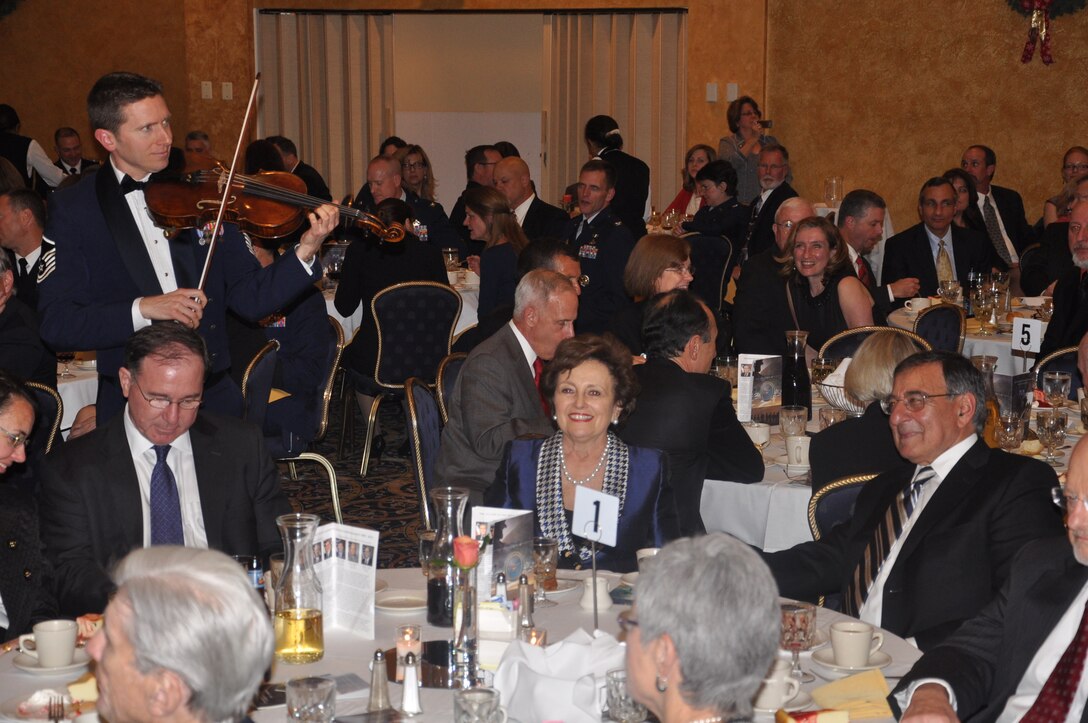 MSgt Bryce Bunner serenading SECDEF Panetta and his wife during one of our holiday event. (U.S. Air Force photo by TSgt Ni Santiago)
