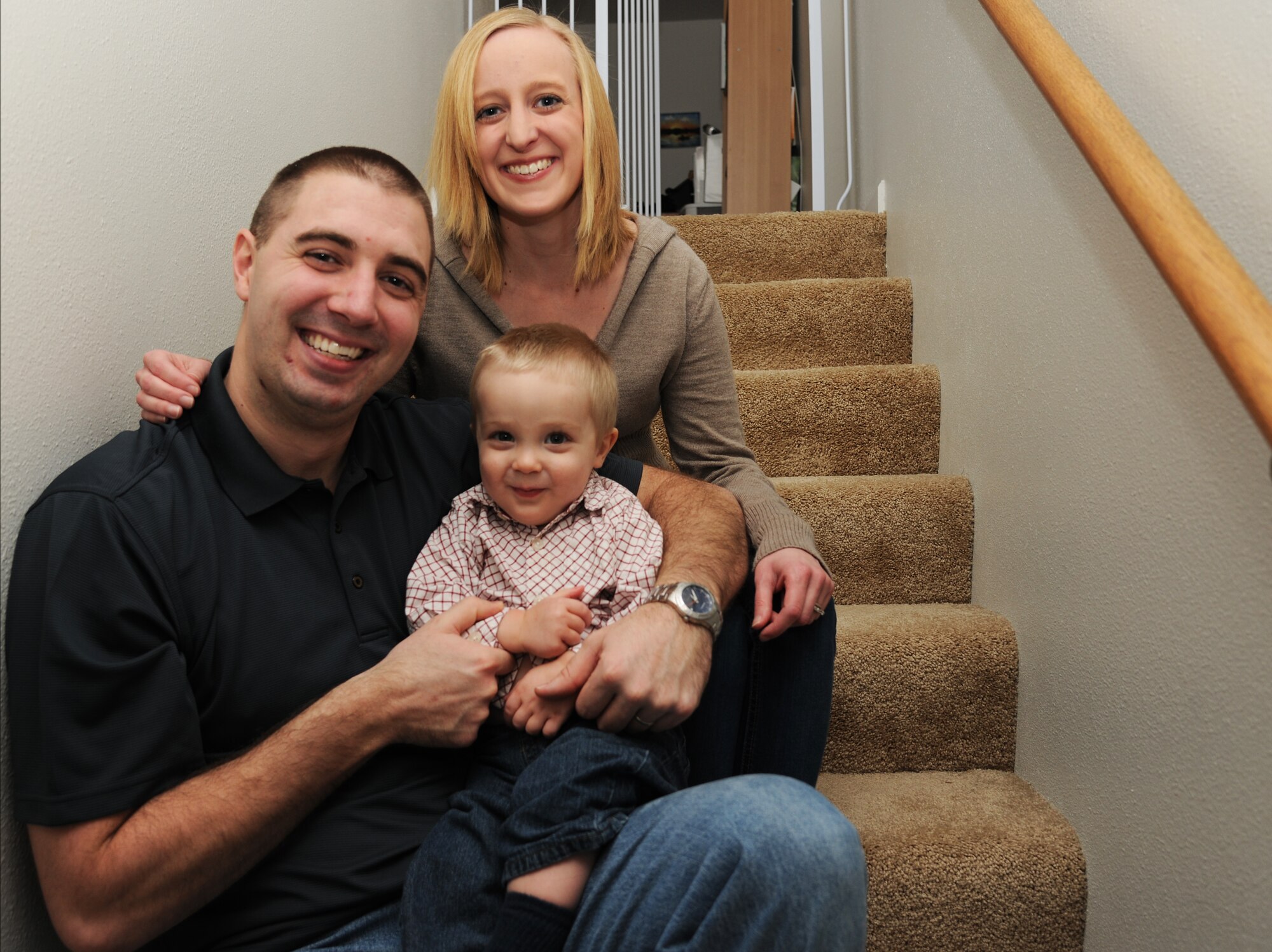 Senior Airman Adam Runyan, 69th Maintenance Squadron network systems technician, and his wife, Bethanne, smile with their son Jan 2, 2013, on Grand Forks Air Force Base, N.D. Runyan said he would love to be remembered as a man who had big goals and saw them through to completion, reminiscent of the actions of President Theodore Roosevelt, who Runyan said has served as a figure of inspiration in his life. (U.S. Air Force photo/Senior Airman Derek VanHorn)