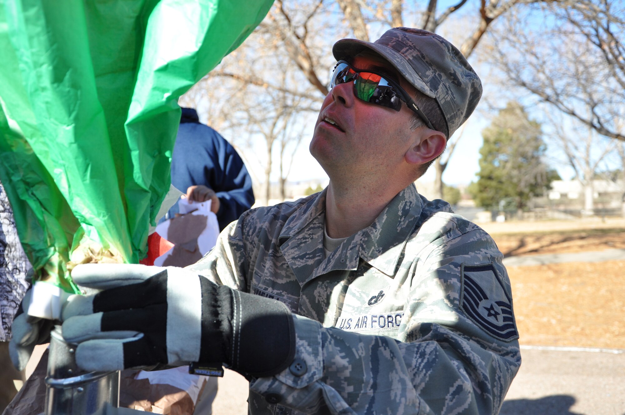Master Sgt. Alex Vieira, NCO in charge USAF Academy Winds Band, helps Swigert Academy students inflate their hand-made hot air balloons Dec. 17, 2012, at Swigert Academy. As a STEAM school, Swigert Academy emphasizes the importance of math and science to its students while preparing them for the future through an academically challenging environment while fostering creativity and teamwork. (U.S. Air Force photo/Staff Sgt. J. Aaron Breeden)