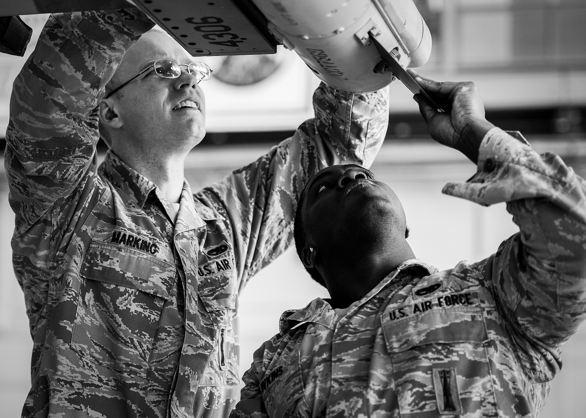 Senior Airmen Tyler Marking and Kevin Hawkins, of the 96th Aircraft Maintenance Squadron Blue, place the fins on the AIM-120 during the 2012 Loadcrew of the Year competition Jan. 18 at Eglin Air Force Base, Fla.  The best of the best maintainers from AMU Red and Blue battled for the title of this yearly competition.  The Blue Team was timed and judged for accuracy of their weapons load of an F-16, while the Red Team was evaluated on an F-15. Although the Blue Team finished first, the competition is still being judged.  The winners will be announced at the 46th Maintenance Group annual awards banquet in March. (U.S. Air Force photo/Samuel King Jr.)