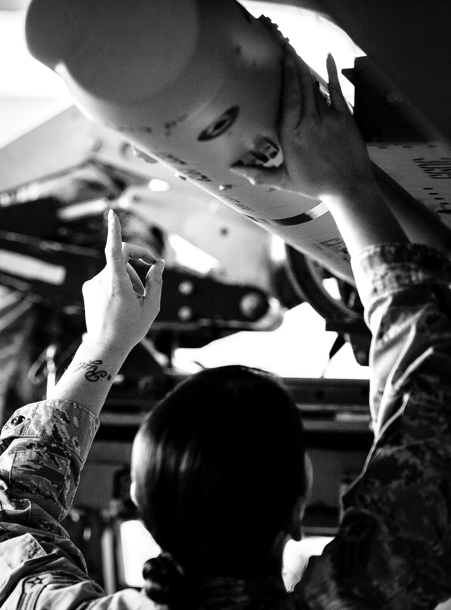 Senior Airman Melissa Higa, of the 96th Aircraft Maintenance Squadron Red, gives directions to the weapons loader during the 2012 Loadcrew of the Year competition Jan. 18 at Eglin Air Force Base, Fla.  The best of the best maintainers from AMU Red and Blue battled for the title of this yearly competition.  The Red Team was timed and judged for accuracy of their weapons load of an F-15, while the Blue Team was evaluated on an F-16. Although the Blue Team finished first, the competition is still being judged.  The winners will be announced at the 46th Maintenance Group annual awards banquet in March. (U.S. Air Force photo/Samuel King Jr.)