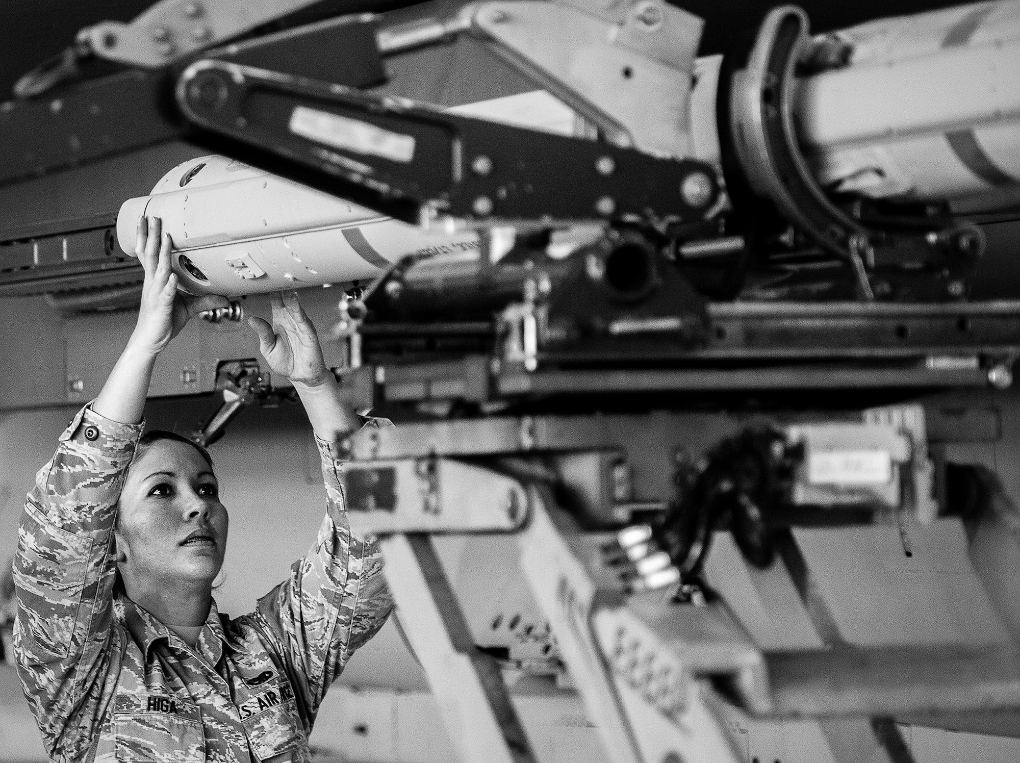 Senior Airman Melissa Higa, of the 96th Aircraft Maintenance Squadron Red, helps move the AIM-120 into place during the 2012 Loadcrew of the Year competition Jan. 18 at Eglin Air Force Base, Fla.  The best of the best maintainers from AMU Red and Blue battled for the title of this yearly competition.  The Red Team was timed and judged for accuracy of their weapons load of an F-15, while the Blue Team was evaluated on an F-16. Although the Blue Team finished first, the competition is still being judged.  The winners will be announced at the 96th Maintenance Group annual awards banquet in March. (U.S. Air Force photo/Samuel King Jr.)