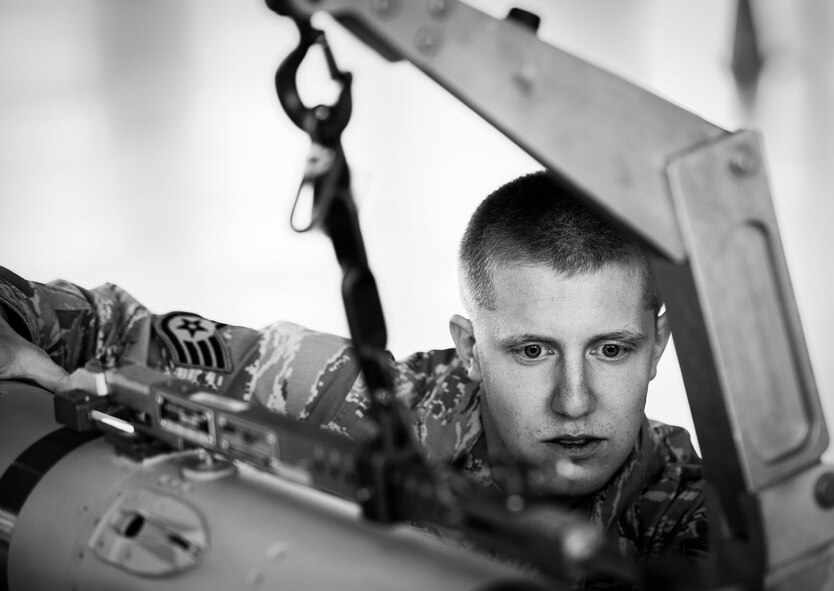 Staff Sgt. Jacob Holst, of the 96th Aircraft Maintenance Squadron Red, ensures the AIM-120 is secure as its being lifted during the 2012 Loadcrew of the Year competition Jan. 18 at Eglin Air Force Base, Fla.  The best of the best maintainers from AMU Red and Blue battled for the title of this yearly competition.  The Red Team was timed and judged for accuracy of their weapons load of an F-15, while the Blue Team was evaluated on an F-16. Although the Blue Team finished first, the competition is still being judged.  The winners will be announced at the 96th Maintenance Group annual awards banquet in March.  (U.S. Air Force photo/Samuel King Jr.)
