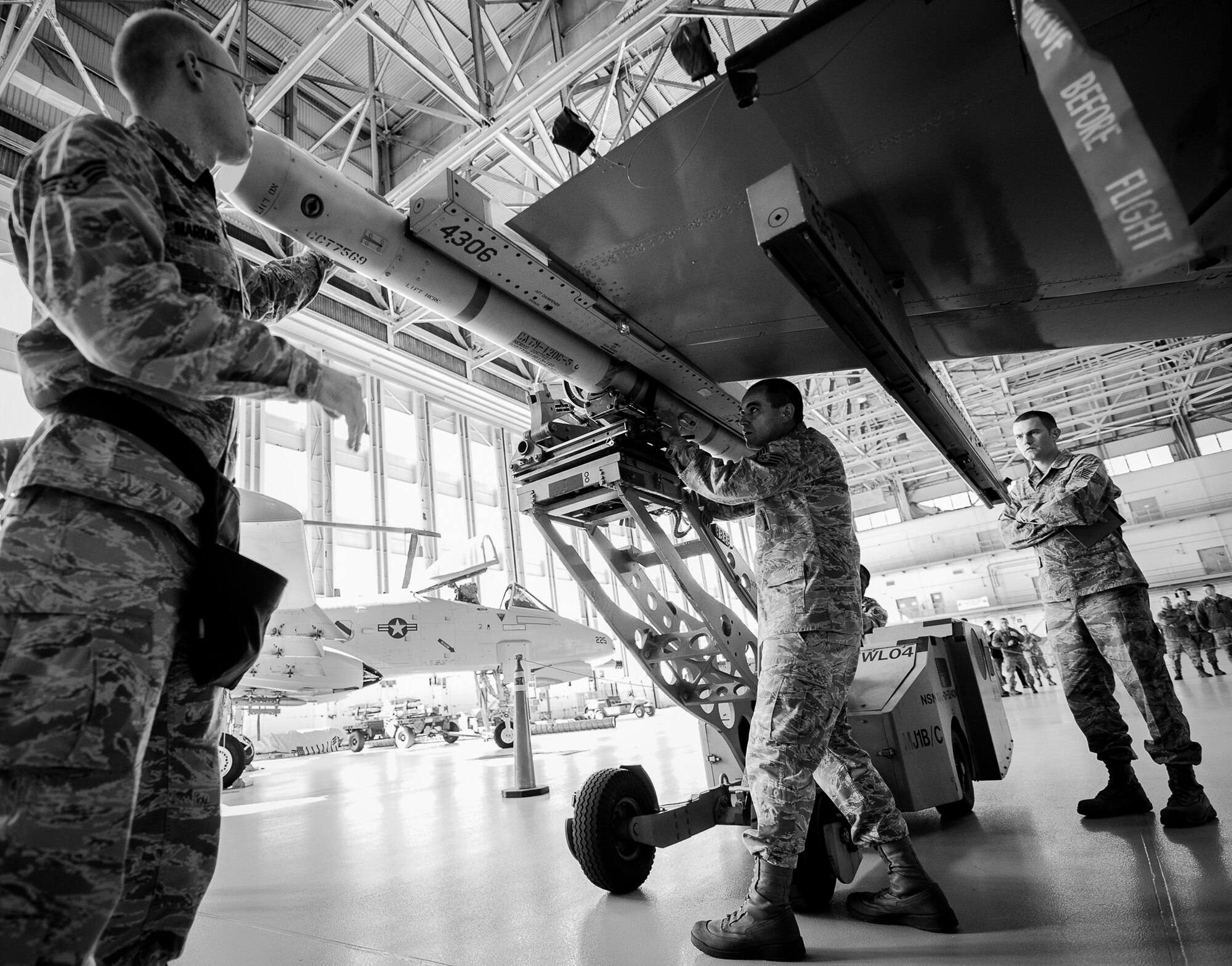 Staff Sgt. Spencer Merritt, of the 96th Aircraft Maintenance Squadron Blue, affixes an AIM-120 onto the wing of an F-16 Fighting Falcon during the 2012 Loadcrew of the Year competition Jan. 18 at Eglin Air Force Base, Fla.  The best of the best maintainers from AMU Red and Blue battled for the title of this yearly competition.  The Blue Team was timed and judged for accuracy of their weapons load of an F-16, while the Red Team was evaluated on an F-15. Although the Blue Team finished first, the competition is still being judged.  The winners will be announced at the 96th Maintenance Group annual awards banquet in March.  (U.S. Air Force photo/Samuel King Jr.)