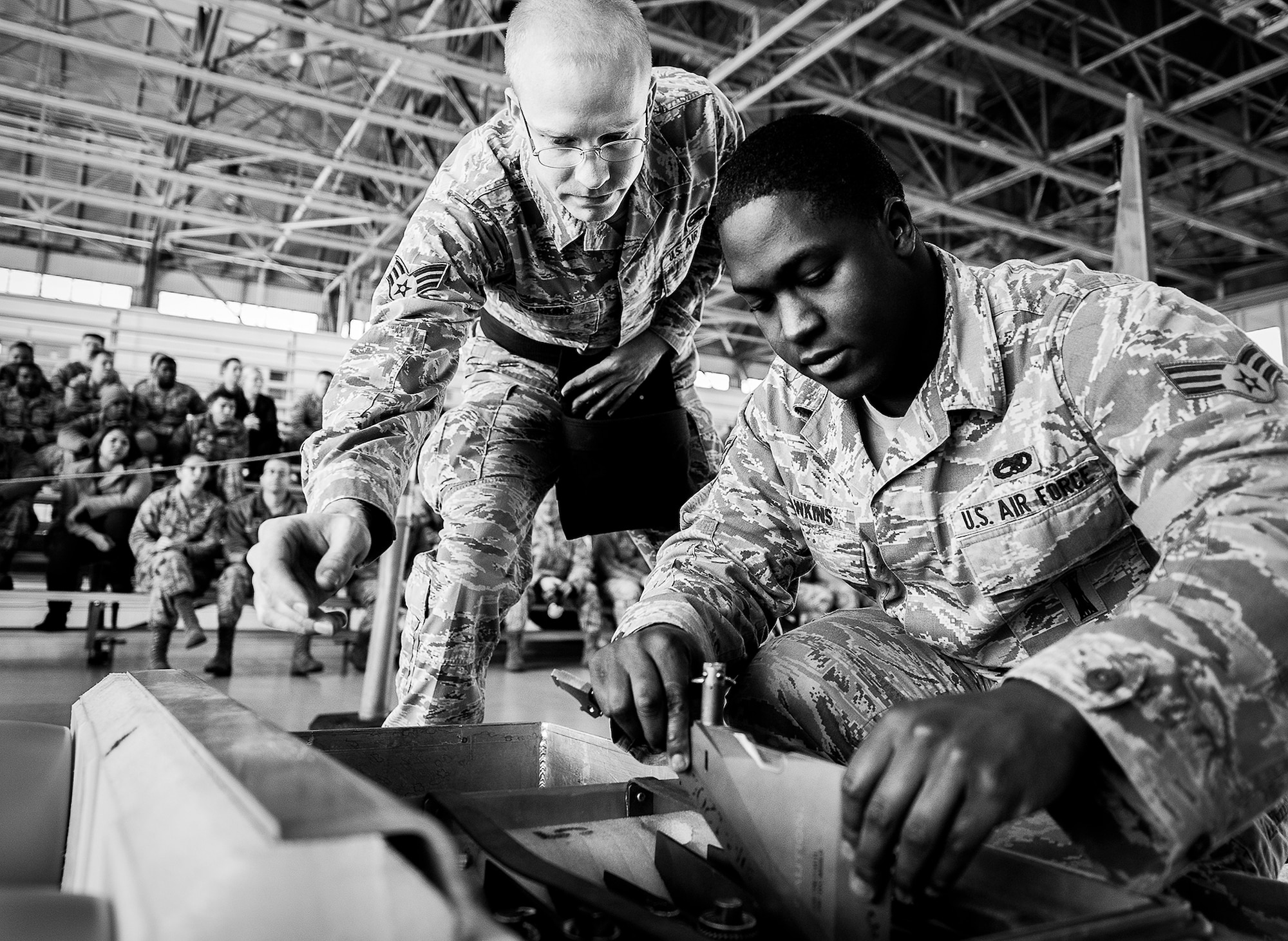 Senior Airmen Kevin Hawkins and Tyler Marking, of the 96th Aircraft Maintenance Squadron Blue, examine the fins and wings to be placed on the AIM-120 during the 2012 Loadcrew of the Year competition Jan. 18 at Eglin Air Force Base, Fla.  The best of the best maintainers from AMU Red and Blue battled for the title of this yearly competition.  The Blue Team was timed and judged for accuracy of their weapons load of an F-16, while the Red Team was evaluated on an F-15. Although the Blue Team finished first, the competition is still being judged.  The winners will be announced at the 96th Maintenance Group annual awards banquet in March.  (U.S. Air Force photo/Samuel King Jr.)