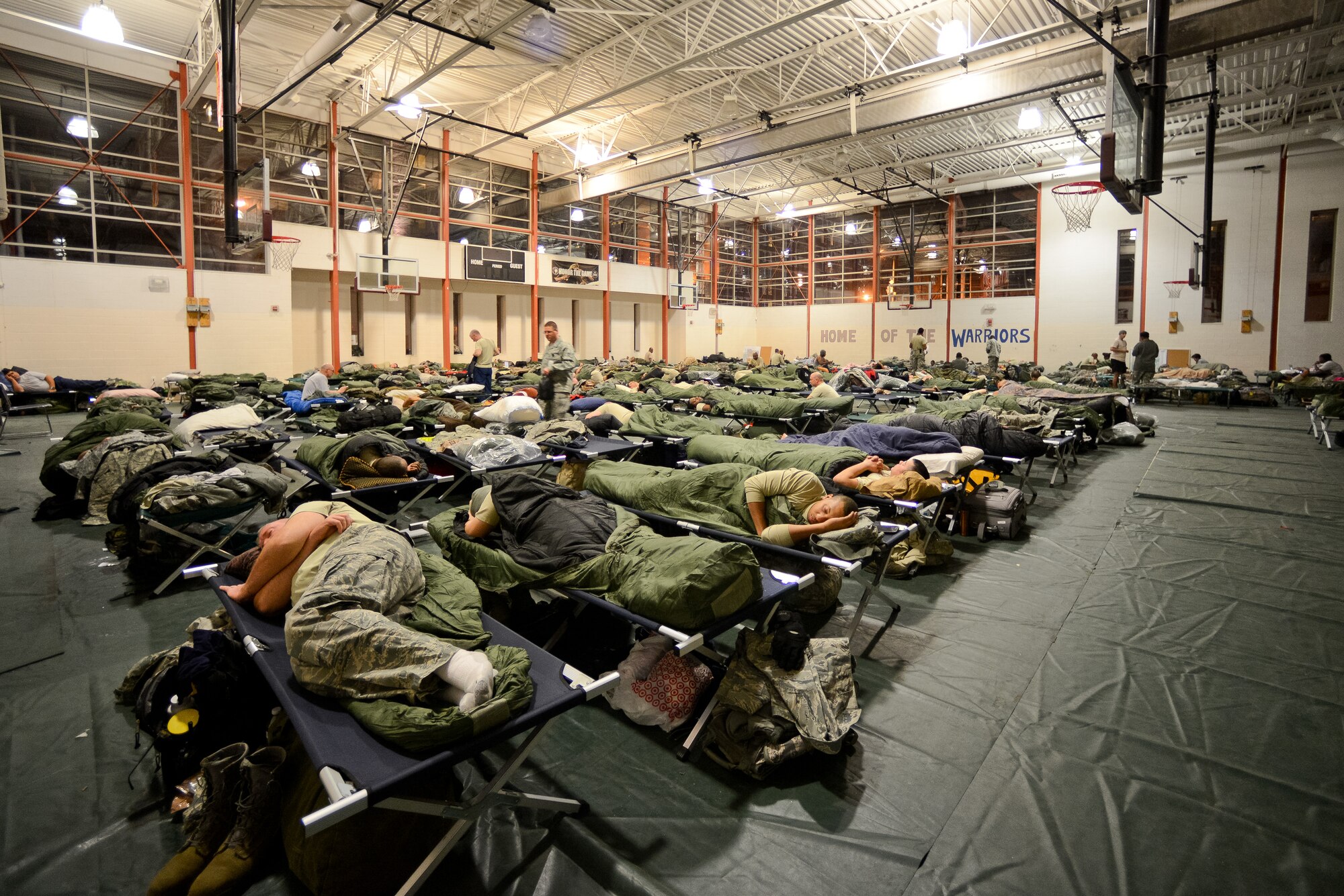 National Guardsmen deployed to the National Capital Region line the floors of the Kennedy Recreation Center for a night of rest while supporting the 57th Presidential Inauguration in Washington, D.C., Jan. 20, 2013.  The recreation center served as a bed down and feeding location for troops deployed to the area.  They were able to enjoy a hot meal at the facility prepared by the Joint STARS 116th Force Support Squadron from Robins Air Force Base, Ga.  (National Guard photo by Master Sgt. Roger Parsons/Released)