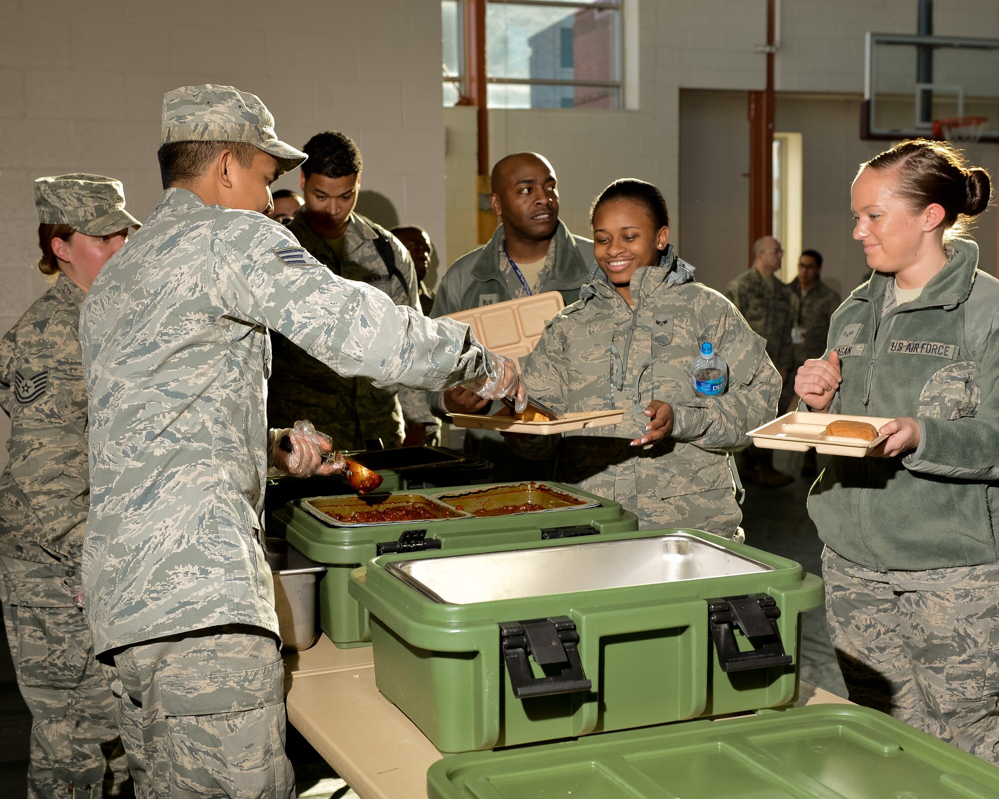 Air National Guardsmen from the Joint STARS 116th Force Support Squadron (FSS), Robins Air Force Base, Ga., serve a hot meal to members of the 113th Fighter Wing, Joint Base Andrews, Md., at the Kennedy Recreation Center in Washington, D.C., Jan. 20, 2013.  The nine person team from Georgia deployed to the National Capital Region joining more than 6,000 Guardsmen from 32 states and territories as part of the Joint Task Force-District of Columbia.  Living and working in field conditions, the primary mission of the 116th FSS was to provide meals from their mobile field kitchen to troops supporting the events surrounding the inauguration.  A secondary mission included being sworn in as Special Police to assist the District of Columbia Police Department as needed. (National Guard photo by Master Sgt. Roger Parsons/Released)