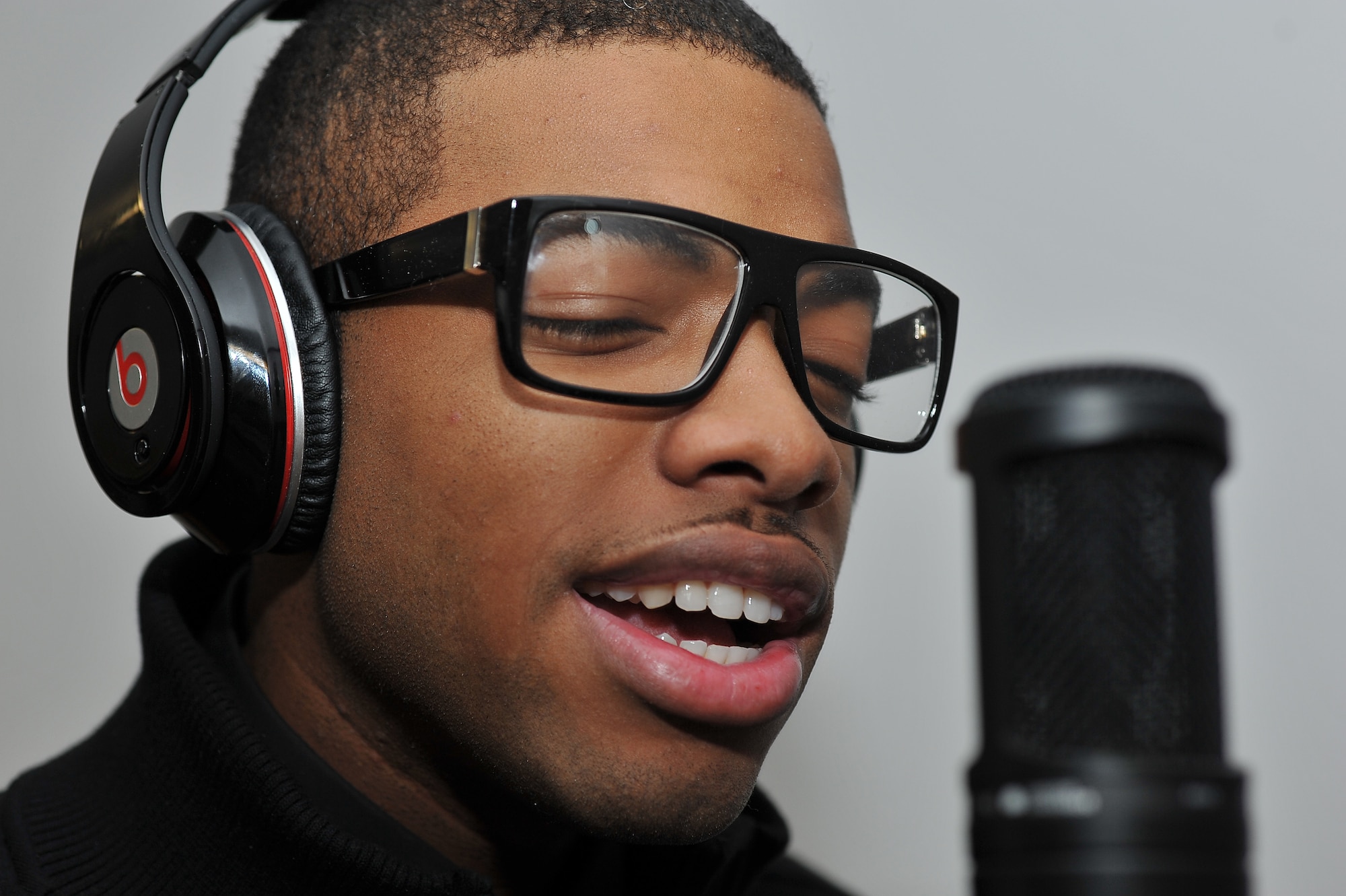 Airman 1st Class Dracy Green records a song in his dormitory on Ramstein Air Base, Germany, Jan. 15, 2013. Green sells his music from an online website that donates 20 percent of its proceeds to charities that support military members on base. (U.S Air Force photo/ Airman 1st Class Dymekre Allen)