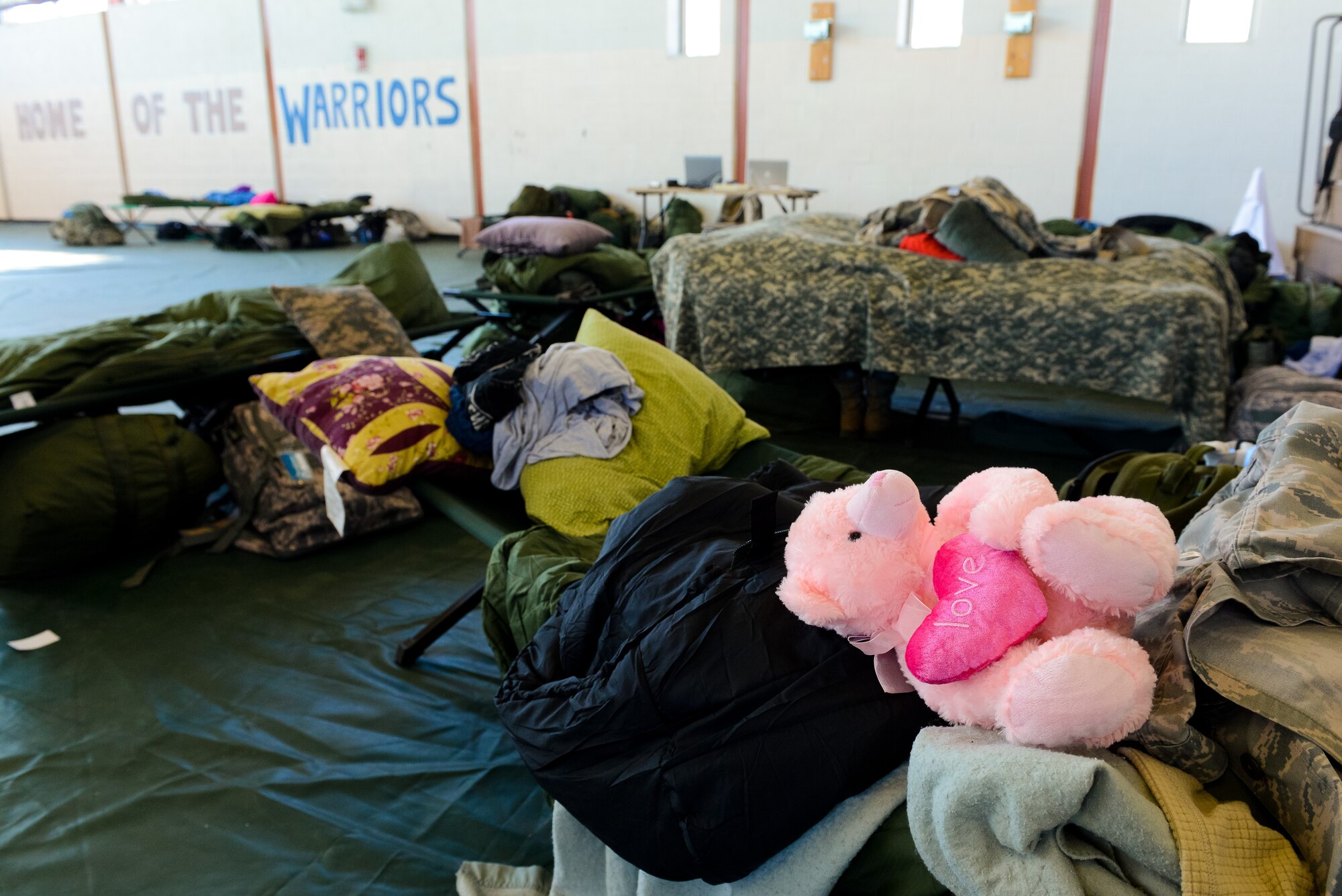 A teddy bear sits on the cot of an Air National Guardsman deployed from the Joint STARS 116th Force Support Squadron (FSS) out of Robins Air Force Base, Ga. at the Kennedy Recreation Center, Washington, D.C., Jan. 18, 2013.  The Guardsmen deployed to the National Capital Region in support of the 57th Presidential Inauguration.  The recreation center served as the temporary home and work center for the 116th FSS where they set up a mobile field kitchen to feed troops supporting the events surrounding the inauguration. 
