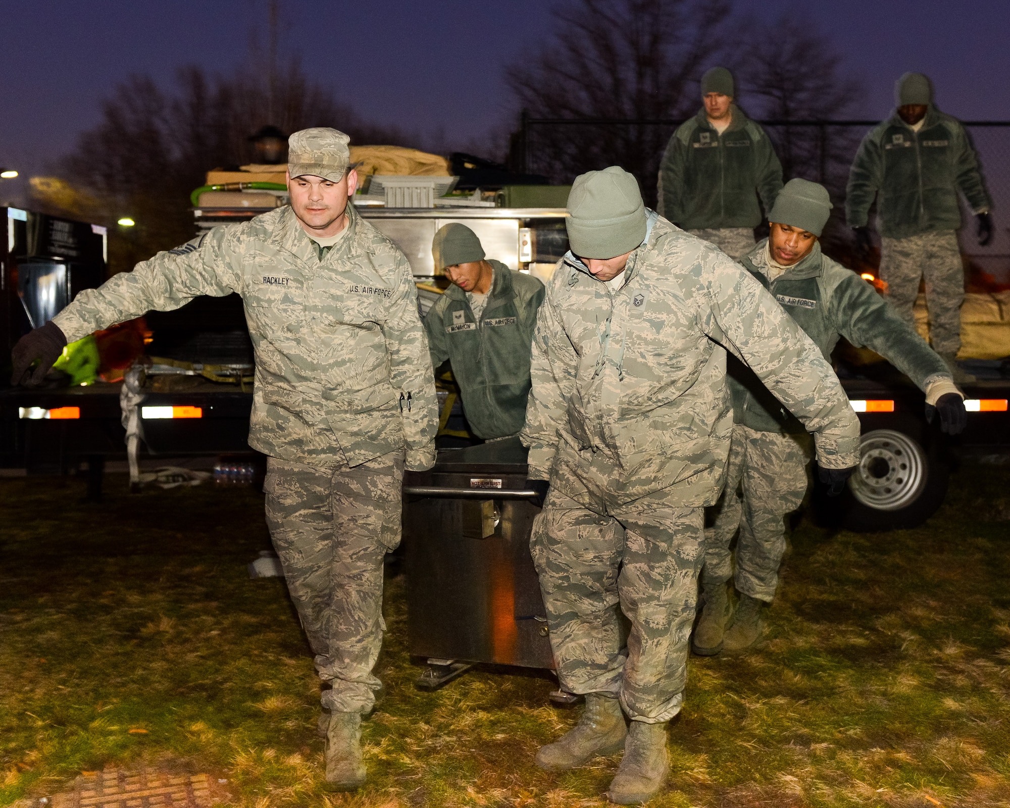 Air National Guardsmen from the Joint STARS 116th Air Control Wing out of Robins Air Force Base, Ga., unload a tray ration heater while setting up a mobile field kitchen at the Kennedy Recreation Center while deployed to the National Capital Region in support of the 57th Presidential Inauguration, Washington, D.C., Jan. 18, 2013.  The Guardsmen deployed with the 116th Force Support Squadron (FSS), joining more than 6,000 Guardsmen from 26 states and territories as part of the Joint Task Force-District of Columbia.  Living and working in field conditions, the primary mission of the 116th FSS was to provide meals from their mobile field kitchen to troops supporting the events surrounding the inauguration.  A secondary mission included being sworn in as Special Police to assist the District of Columbia Police Department as needed. (National Guard photo by Master Sgt. Roger Parsons/Released)