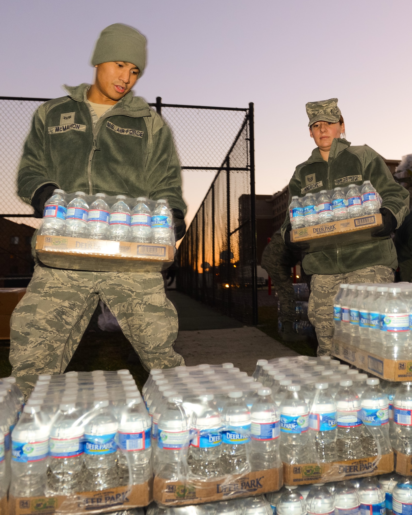 Air National Guard Senior Airman Daniel McMahon and Tech. Sgt. Melissa Hendricks, both with the 116th Force Support Squadron (FSS) out of Robins Air Force Base, Ga., unload water while setting up a mobile field kitchen at the Kennedy Recreation Center while deployed to the National Capital Region in support of the 57th Presidential Inauguration, Washington, D.C., Jan. 18, 2013.  The Guardsmen were part of a nine person team joining more than 6,000 Guardsmen from 26 states and territories as part of the Joint Task Force-District of Columbia.  Living and working in field conditions, the primary mission of the 116th FSS was to provide meals from their mobile field kitchen to troops supporting the events surrounding the inauguration.  A secondary mission included being sworn in as Special Police to assist the District of Columbia Police Department as needed. (National Guard photo by Master Sgt. Roger Parsons/Released)