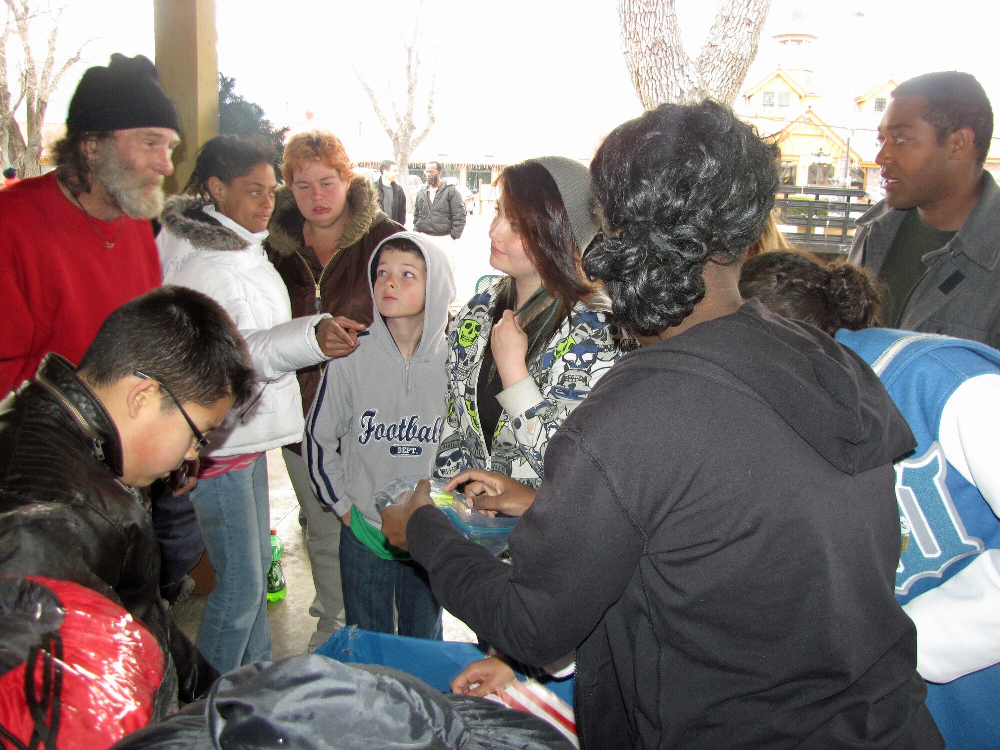Teens from the Keystone Club at the R.P. Lee Youth Center pass out hygiene packets during the Holidays for the Homeless dinner Dec. 22. The teens served 250 meals to the homeless downtown and passed out  213 hygiene packets, as well as coats, scarves, gloves, hats, shoes and toys. The dinner was part of the teens project Hope for the Homeless which runs through August. (Courtesy photo)