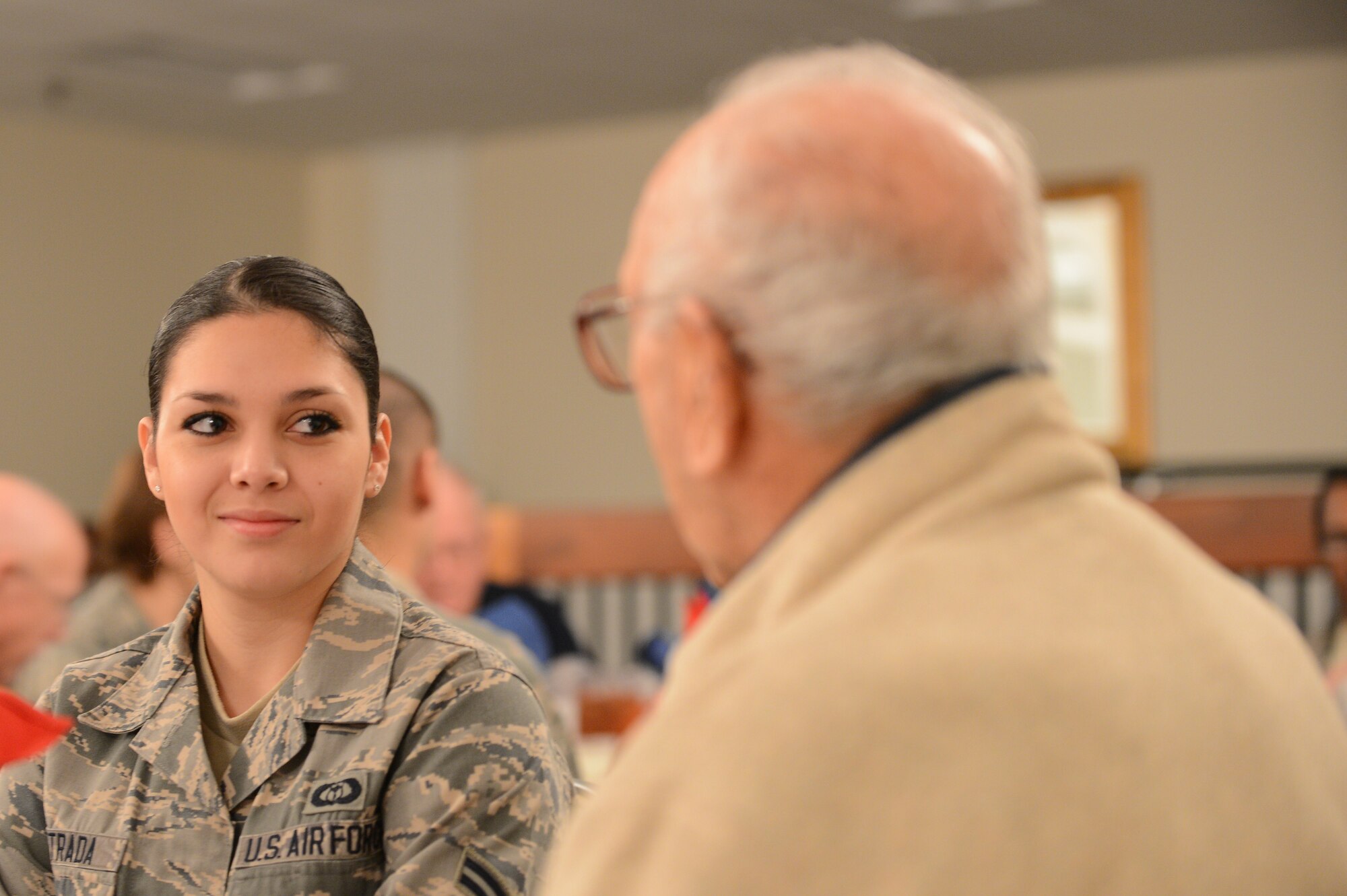 U.S. Airman 1st Class Jessica Estrada, 28th Operational Weather squadron weather journeyman talks to U.S. Army Sgt. ret. John Zyber at Shaw Air Force Base, S.C., Jan. 22, 2013.  Veterans toured Shaw and visited the 79th Fighter Squadron as well as the weapons load barn where they were briefed on operations at Shaw and the procedures for loading weapons onto aircraft. (U.S. Air Force photo by Airman 1st Class Nicole Sikorski/Released)