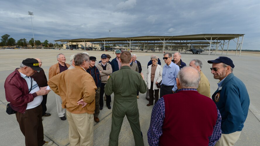 U.S. Air Force Capt. Russ Cleeton, 79th Fighter Squadron pilot, briefs retirees next to an F-16 Fighting Falcon at Shaw Air Force Base, S.C., Jan. 16, 2013. Veterans toured Shaw and visited the 79th Fighter Squadron, as well as the weapons load barn where they were briefed on operations at Shaw and the procedures for loading weapons onto aircraft. (U.S. Air Force photo by Airman 1st Class Nicole Sikorski/Released) 