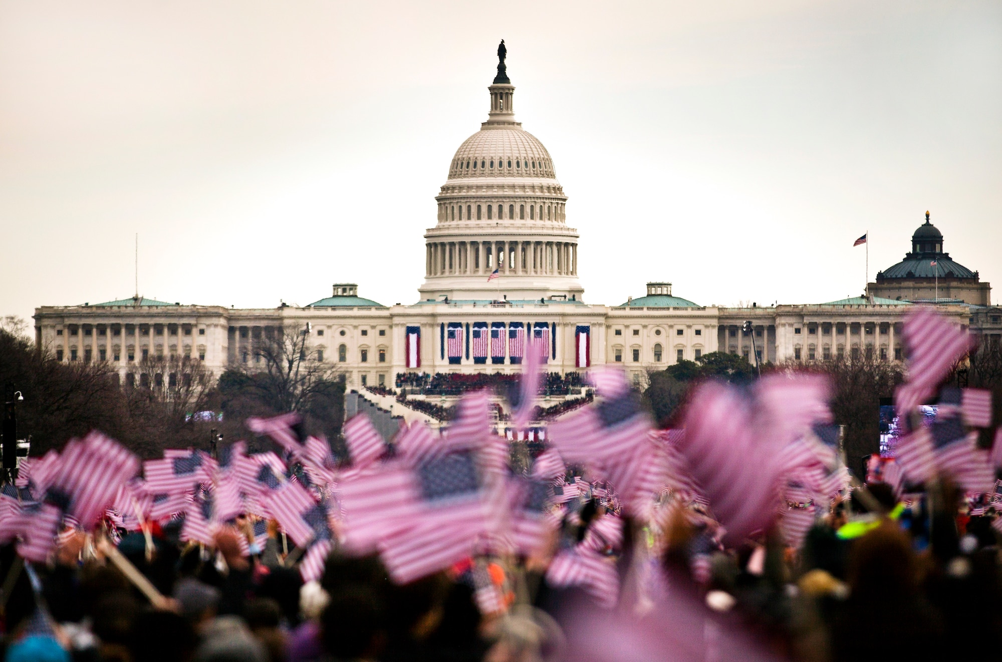 Audience members wave flags from the National Mall during the 57th Inauguration Day events in Washington, D.C., Jan. 21, 2013. More than 180 Marines from Marine Barracks Washington marched in the inaugural parade behind the U.S. Marine Corps Band, known as "The President's Own." (U.S. Marine Corps photo by Staff Sgt. Mark Fayloga/Released)