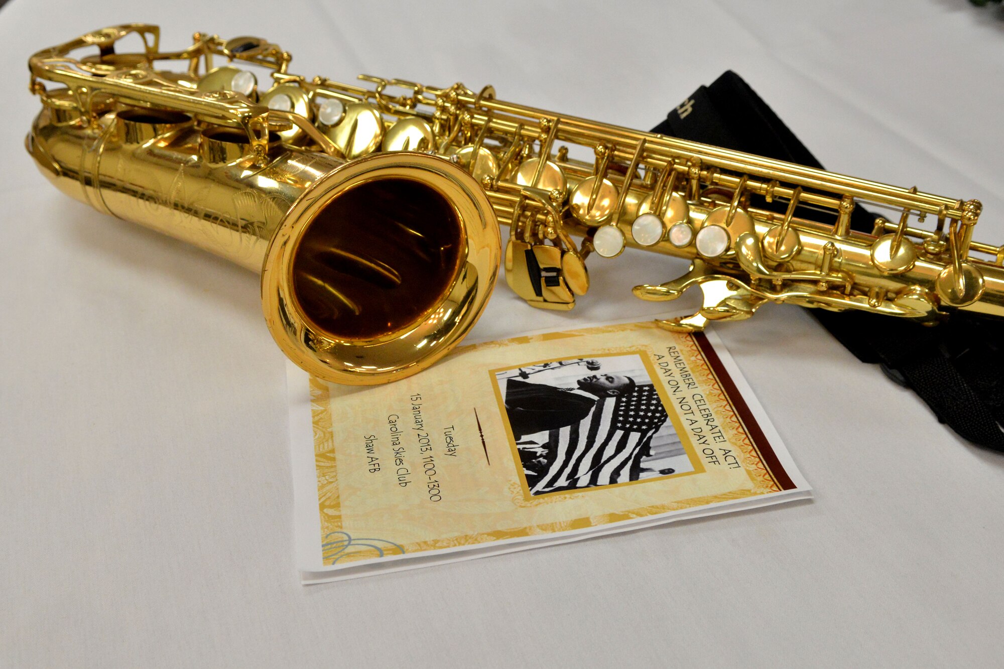 A saxophone lies next to a brochure of the Martin Luther King luncheon, Shaw Air Force Base, S.C. Jan.15, 2013. The saxophone was a big part of the musical selection played at the event. (U.S. Air Force photo by Airman 1st Class Ashley L. Gardner/Released)
