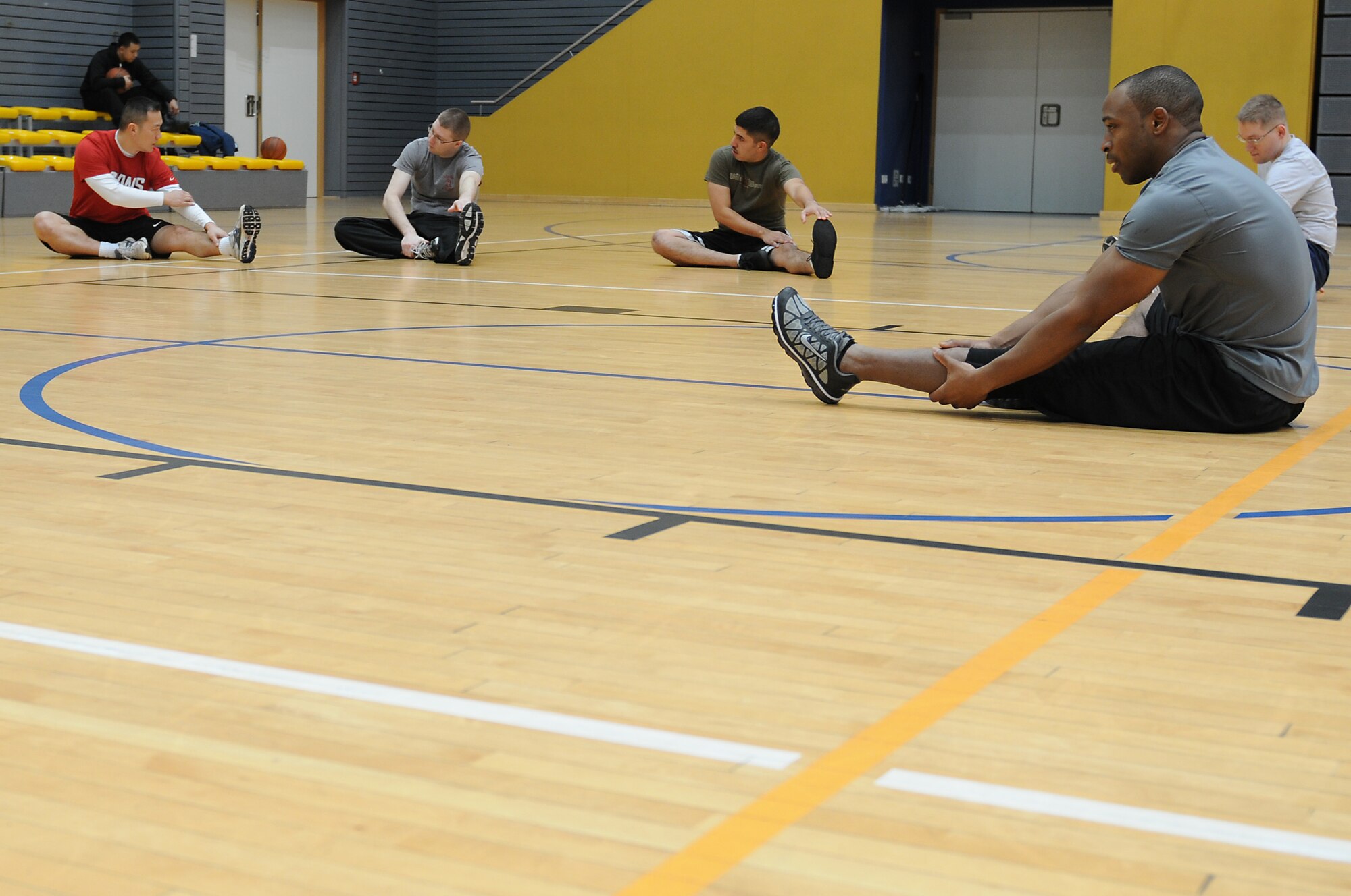 Tech. Sgt. Toriano Banks, 86th Comptroller Squadron, financial analyst, leads Airmen of CPTS in different stretches before their individual workout at the South Side Fitness Center on Ramstein Air Base, Germany, Jan. 18, 2012. As a Physical Training Leader, Banks helps the Airmen of CPTS maintain physical fitness standards. (U.S. Air Force photo/Airman 1st Class Holly Cook)