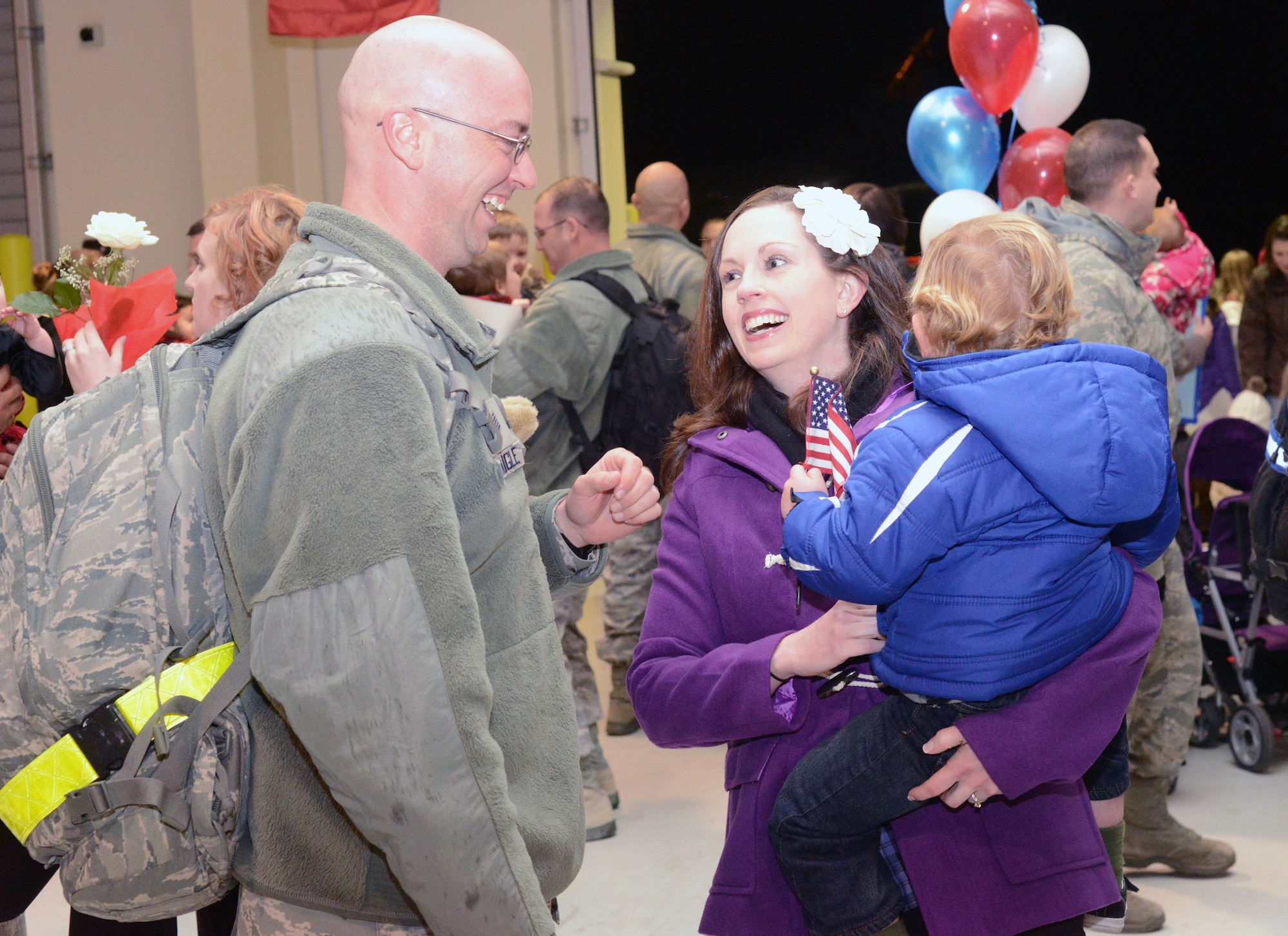 Loved ones reunite after returning from a six-month deployment to Southwest Asia Jan. 19, 2013 at Aviano Air base, Italy. The squadron has had a rich history with its roots reaching back to the very beginnings of the Air Force. It was first activated Dec. 31, 1945, under the U.S. Army Air Corps. The squadron's early years provided air control for major air operations from World War II to include supporting the Berlin Airlift.(U.S. Air Force photo/Senior Airman Michael Battles)