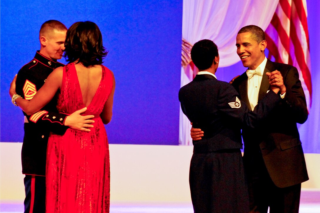 President Barack Obama dances with Air Force Staff Sgt. Bria Nelson, and First Lady Michelle Obama dances with Marine Corps Gunnery Sgt. Timothy Easterling during the Commander In Chief's Ball in Washington, D.C., Jan. 21, 2013.