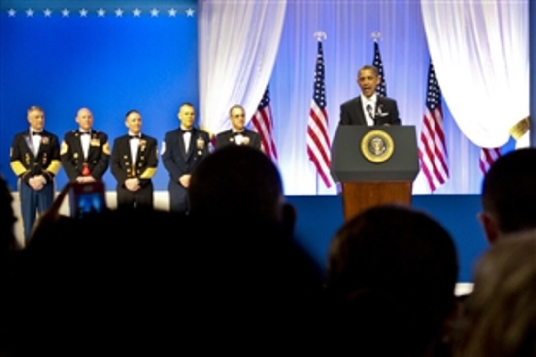 President Barack Obama delivers remarks as senior enlisted members representing the separate services look on at the Commander in Chief's Ball in Washington, D.C., Jan. 21, 2013.