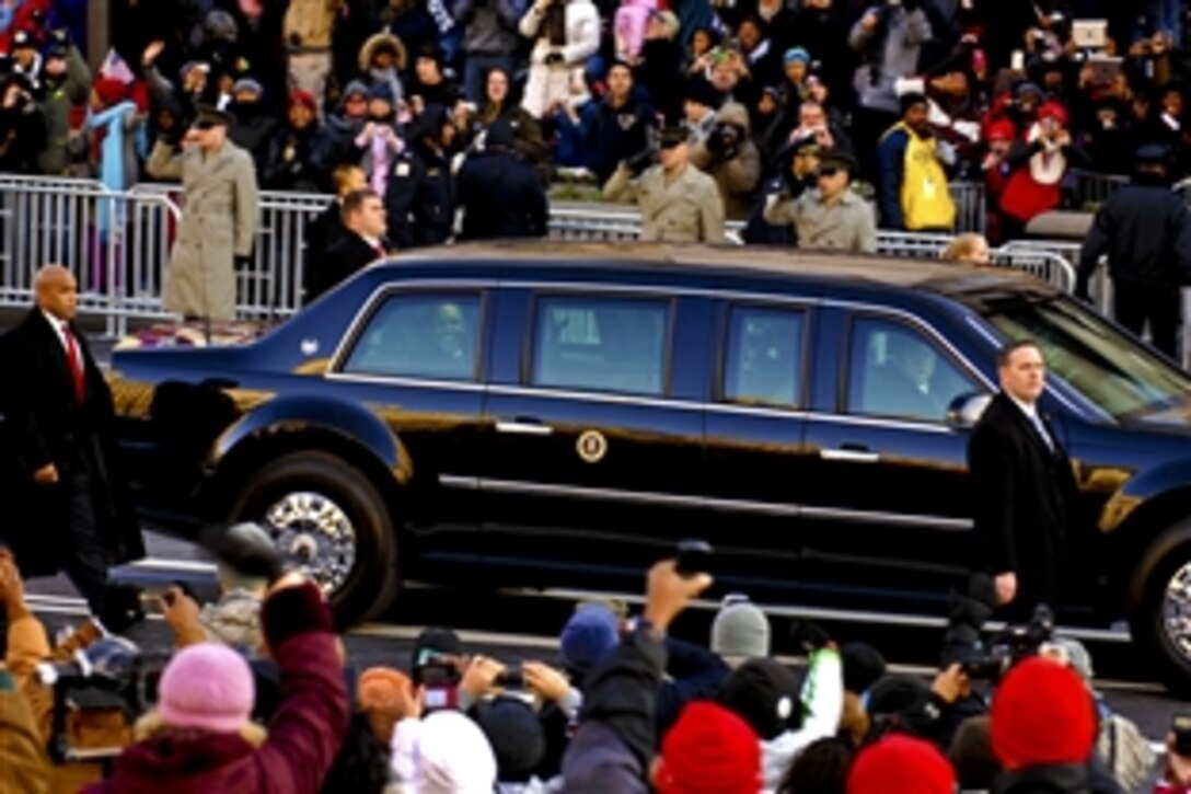President Barack Obama smiles before waving to people as
he travels down Pennsylvania Avenue from the U.S. Capitol to the White House during the 57th Inaugural Day parade in Washington, D.C., Jan. 21, 2013. 