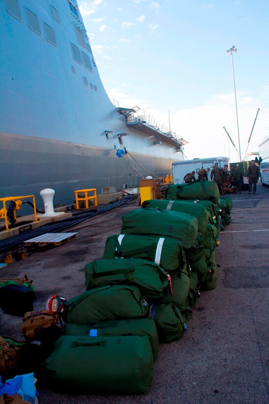 Marines of the 26th Marine Expeditionary Unit (MEU) and its reinforcements board the USS Kearsarge at Naval Station Norfolk, Va., Jan. 21, 2013. The MEU and Amphibious Squadron (PHIBRON) 4 are conducting PHIBRON-MEU Integration in preparation for their Composite Training Unit Exercise, the final phase of a six-month pre-deployment training program. The 26th MEU operates continuously across the globe, providing the president and unified combatant commanders with a forward-deployed, sea-based quick reaction force. The MEU is a Marine Air-Ground Task Force capable of conducting amphibious operations, crisis response and limited contingency operations. (U.S. Marine Corps photo by Cpl. Michael S. Lockett/Released)