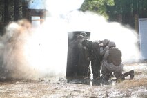 Debris from an explosion engulfs a breaching team with Bridge Company, 8th Engineer Support Battalion, 2nd Marine Logistics Group during the unit’s urban breaching and demolition exercise aboard Camp Lejeune, N.C., Jan. 18, 2013. Teams of Marines huddled behind protective blankets before detonating explosives they placed on doors and walls at their training range. 