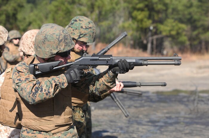 A line of Marines with Bridge Company, 8th Engineer Support Battalion, 2nd Marine Logistics Group fire M-1014 Joint Service Combat Shotguns at a rage aboard Camp Lejeune, N.C., Jan. 18, 2013. The Marines used the shotguns to breach doors during the unit’s urban breaching and demolition exercise. 