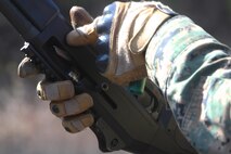 A Marine with Bridge Company, 8th Engineer Support Battalion, 2nd Marine Logistics Group reloads the M-1014 Joint Service Combat Shotgun during the unit’s urban breaching and demolition training aboard Camp Lejeune, N.C., Jan. 18, 2013. The Marines fired slugs from the shotguns to blast through door locks in preparations for assault teams. 