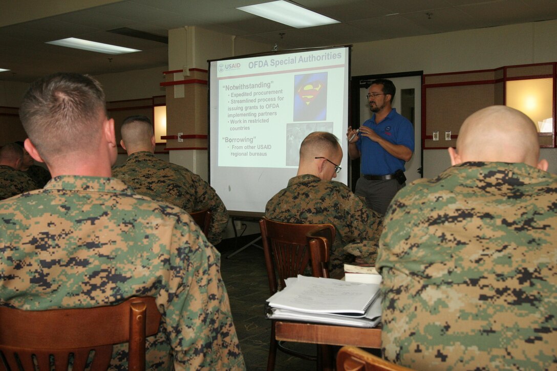Mr. Yoni Bock, Humanitarian Assistance Advisor to the Military, Office of U.S. Foreign Disaster Assistance (OFDA), United States Agency for International Development (USAID), teaches Marines and sailors of III Marine Expeditionary Force about civil-military roles in international disaster response during a Joint Humanitarian Operations Course (JHOC) aboard Camp Courtney, Okinawa, Japan, Jan. 17, 2013.(U.S. Marine Corps photo by CWO2 Jonathan C. Knauth/Released)