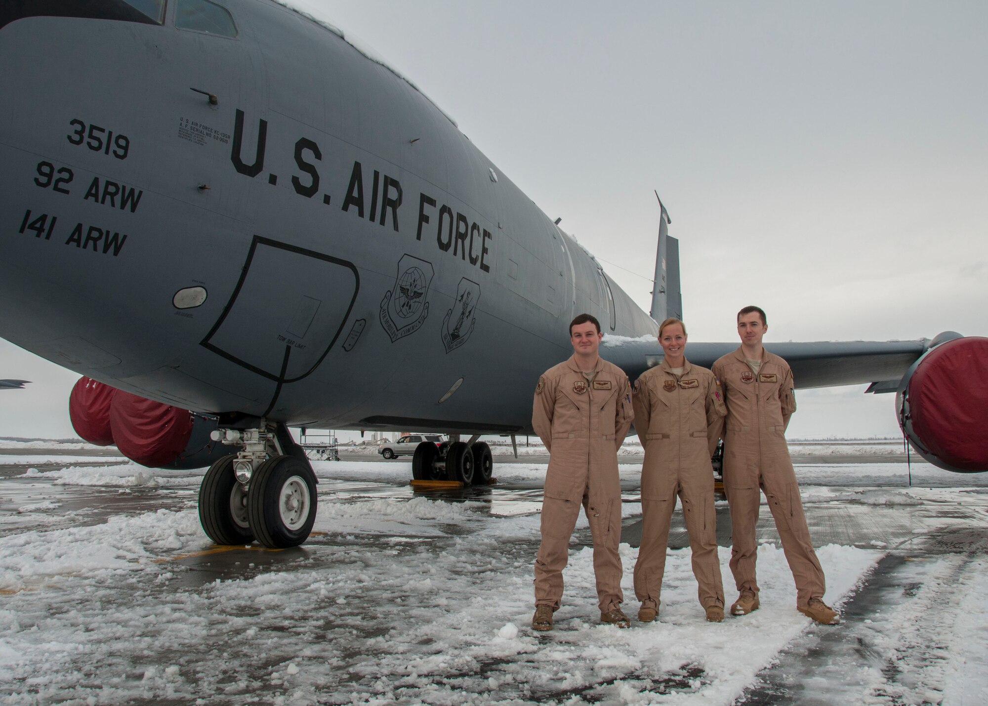 Left to right, Senior Airman Bobby Cash, Maj. Christina Thompson and 1st Lt. Greg Jemo, 22nd Expeditionary Air Refueling Squadron Crew 13, stand by a KC-135 Stratotanker at Transit Center at Manas, Kyrgyzstan, Jan. 12, 2013. Earlier in the month, the crew flew the 30,000th combat flight hour for the Roll-On Beyond Line of Sight Enhancement data link system, a mobile command and control node that enhances communication capabilities for air-to-ground and air-to-air units. (U.S. Air Force photo/Tech. Sgt. Rachel Martinez)