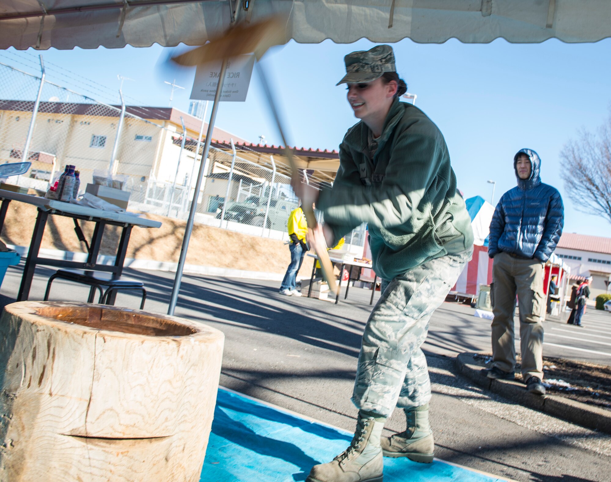 YOKOTA AIR BASE, Japan -- An Airman pounds rice into mochi during the Japanese Welfare Association Japan Culture Day Jan. 18, 2013, at Yokota Air Base, Japan. Approximately 400 people attended the event, which was designed to promote cultural exchange between Yokota’s Japanese employees and base residents. (U.S. Air Force photo by Capt. Raymond Geoffroy)