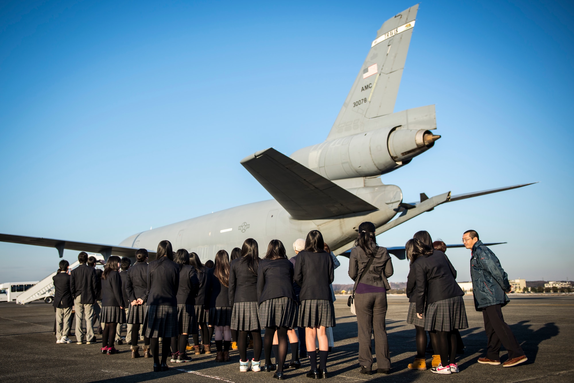 High school students from Japan’s Toyama Prefecture see a U.S. Air Force KC-10 Extender during a tour Jan. 19, 2013, at Yokota Air Base, Japan. The students toured Yokota as a part of a school trip to Akishima, a city neighboring the base. This was the students’ first opportunity to visit a U.S. air base and see military aircraft up close. (U.S. Air Force photo by Capt. Raymond Geoffroy)