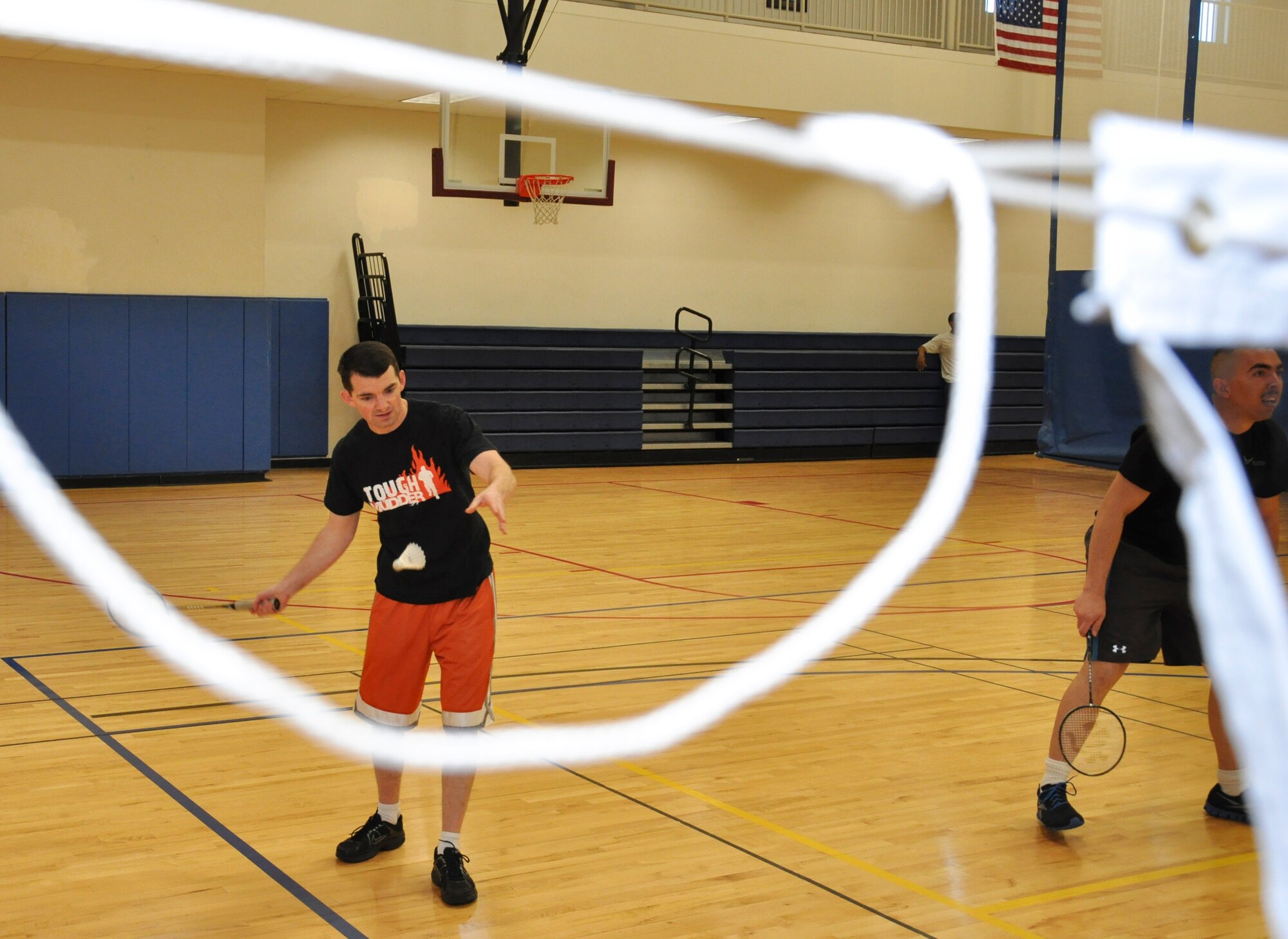 Eric Vesey, 310th Mission Support Group, AFRC, swats the shuttlecock during a badminton tournament Jan. 23, 2013, at the Buckley Fitness Center.  Vesey’s team battled, but it was the 460th Force Support Squadron team that claimed victory. (U.S. photo by Staff Sgt. Nicholas Rau/Released)