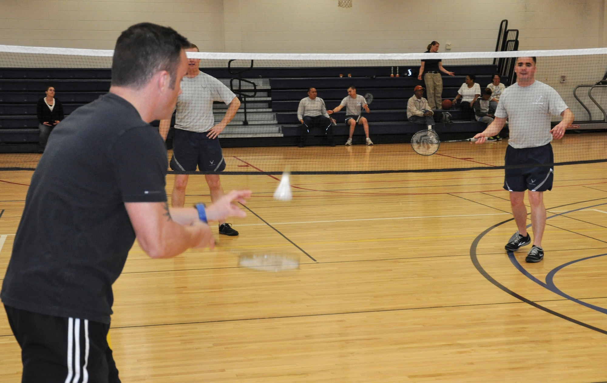 Jonathan McKeever, 460th Medical Group, serves the shuttlecock to his opponents during a badminton tournament Jan. 23, 2013, at the Buckley Fitness Center.  McKeever won his first match before falling from the tournament. (U.S. photo by Staff Sgt. Nicholas Rau/Released)