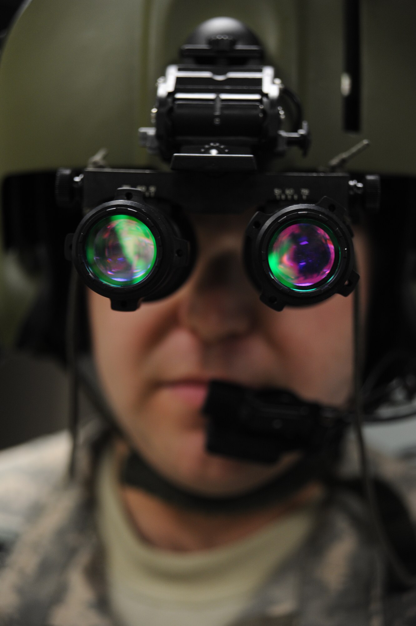 WHITEMAN AIR FORCE BASE, Mo. -- Chief Warrant Officer 2 Thomas Bottini, 1-135th Attack Reconnaissance Battalion AH 64D Apache Longbow pilot, performs operations checks on night-vision goggles, Jan. 16. Night vision goggles aid pilots with nighttime flying and navigation by intensifying ambient light. (U.S. Air Force photo/Staff Sgt. Nick Wilson) (Released) 