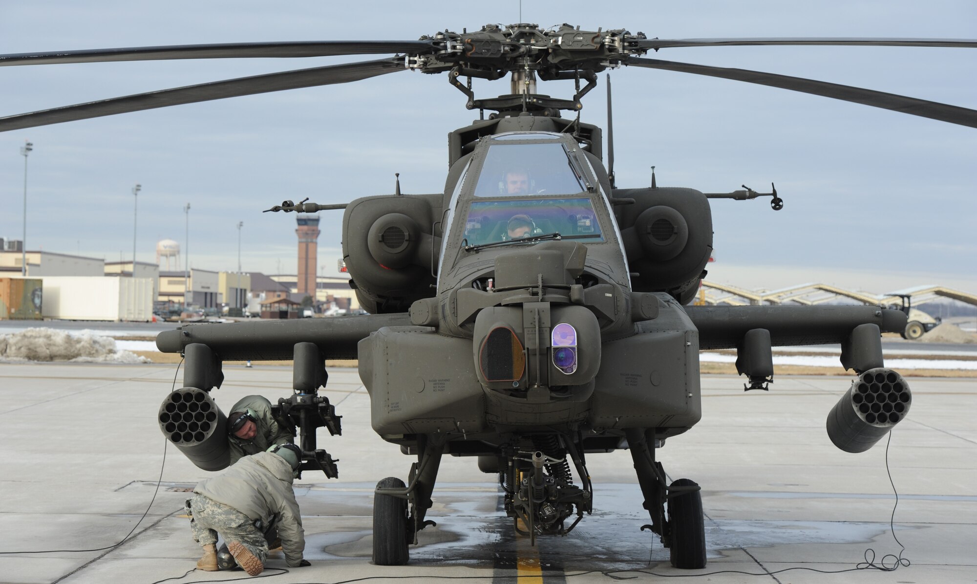 WHITEMAN AIR FORCE BASE, Mo. -- U.S. Army Armament technicians from the 1-135th Attack Reconnaissance Battalion perform daily inspections on an AH 64D Apache Longbow,  Jan. 16. The Apache is a four-blade, twin-engine attack helicopter with a tail wheel-type landing gear arrangement and a cockpit for a crew of two. (U.S. Air Force photo/Staff Sgt. Nick Wilson) (Released)