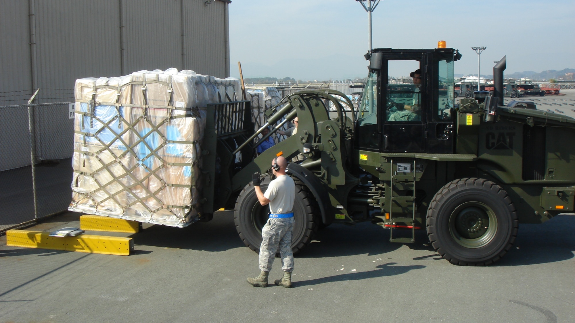 Airmen with the 731st Air Mobility Squadron move a palette to be loaded on an aircraft at Osan Air Base, Republic of Korea. The squadron ensures air cargo and passengers for United States Forces members in Korea are safely transported without interruption. (courtesy photo)