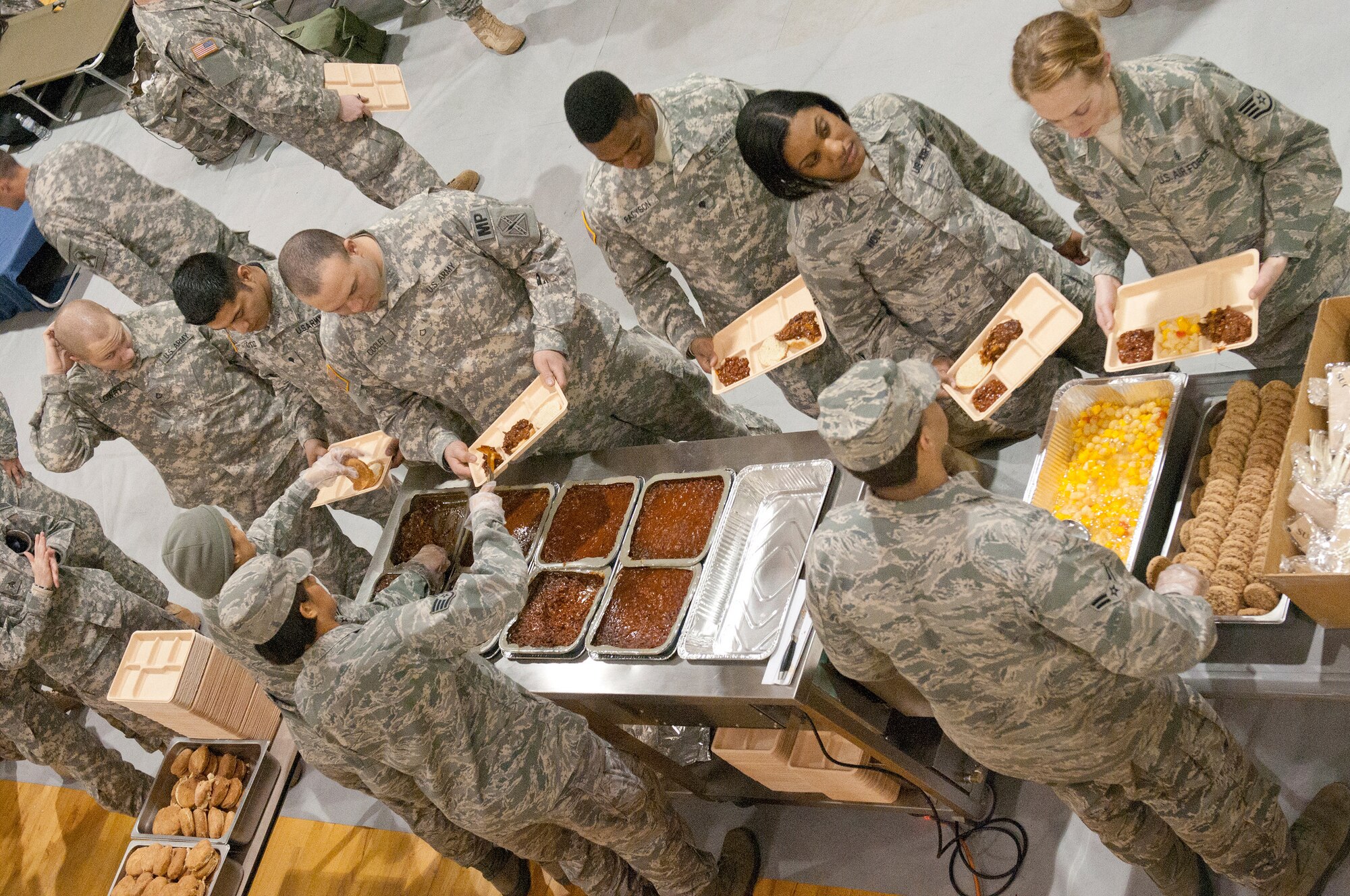 Members of the Kentucky Air National Guard’s 123rd Force Support Squadron serve hot meals to military police and security forces personnel Jan. 19, 2013, at McKinley Technology High School in Washington, D.C., in support of the 57th Presidential Inauguration. Nine members of the Kentucky unit deployed to provide food and lodging services to more than 300 troops. (Kentucky Air National Guard photo by Senior Airman Vicky Spesard)