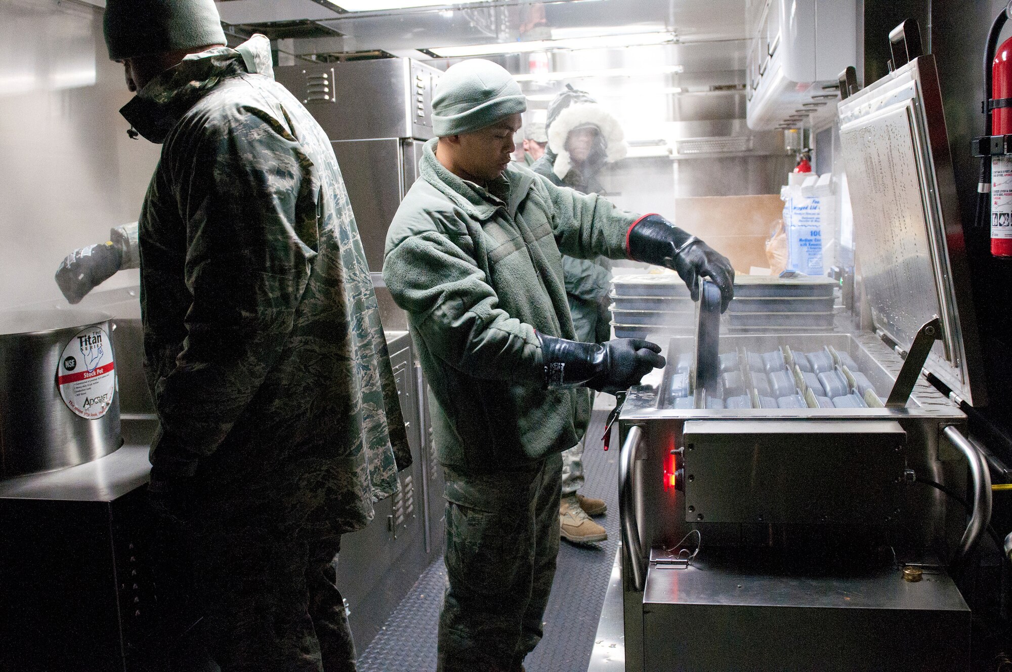 Members of the Kentucky Air National Guard’s 123rd Force Support Squadron prepare meals for deployed Soldiers and Airmen at McKinley Technology High School in Washington, D.C., on Jan. 19, 2013. The Kentucky team served more than 1,800 meals from a Disaster Relief Mobile Kitchen Trailer. (Kentucky Air National Guard photo by Senior Airman Vicky Spesard)